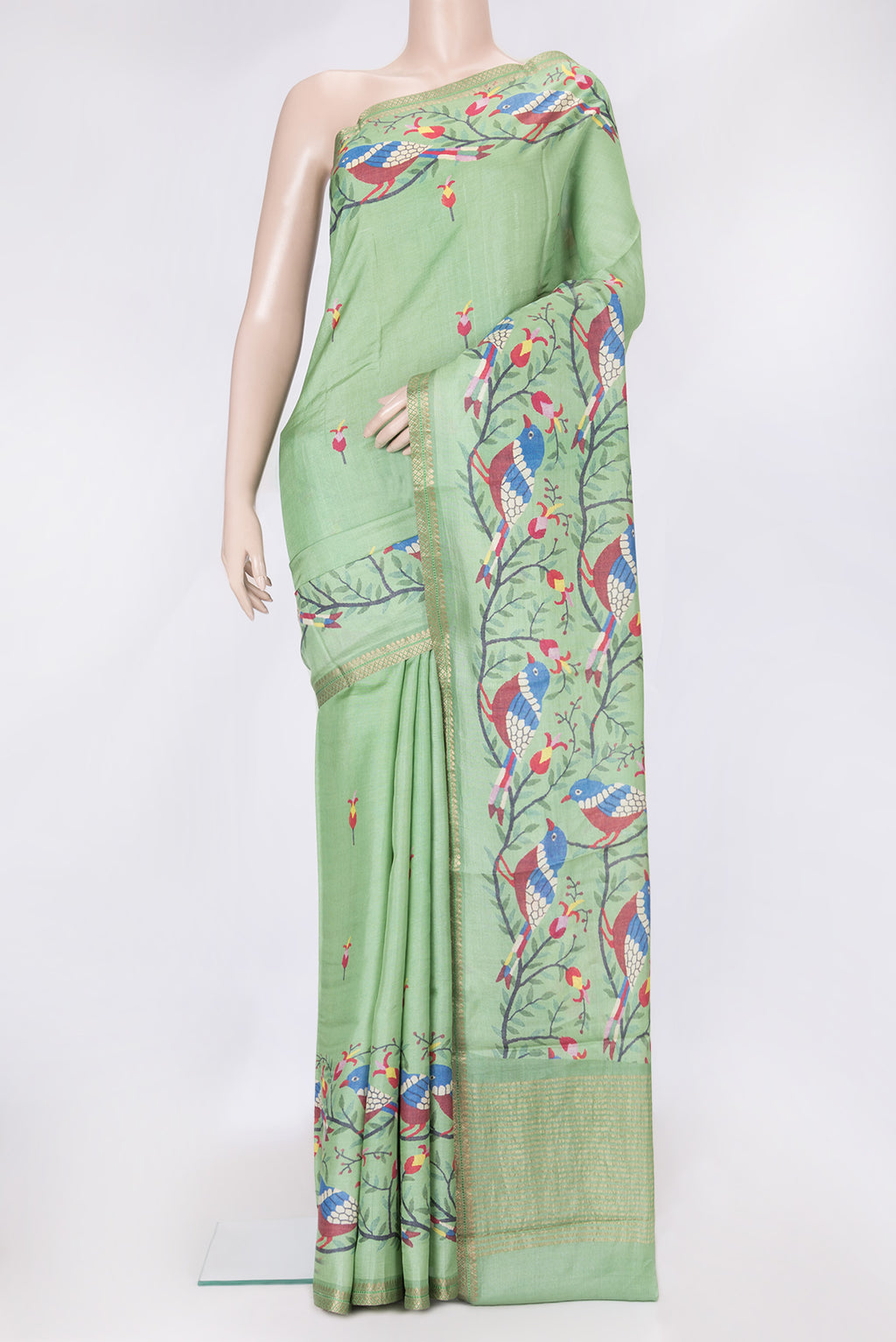 Green Dual Tone Tussar Silk Saree with Printed design on the body and Zari Border.  displayed on a mannequin