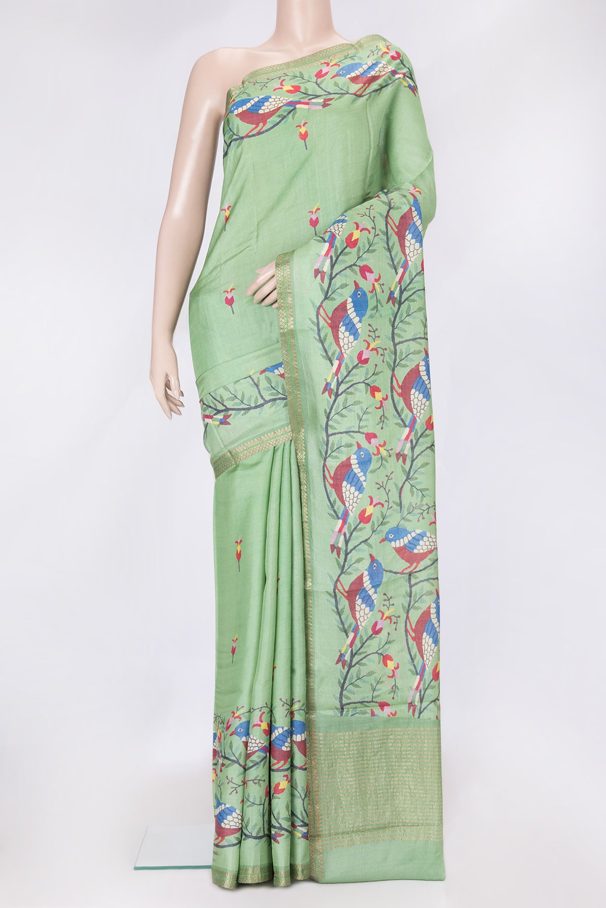 Green Dual Tone Tussar Silk Saree with Printed design on the body and Zari Border.  displayed on a mannequin