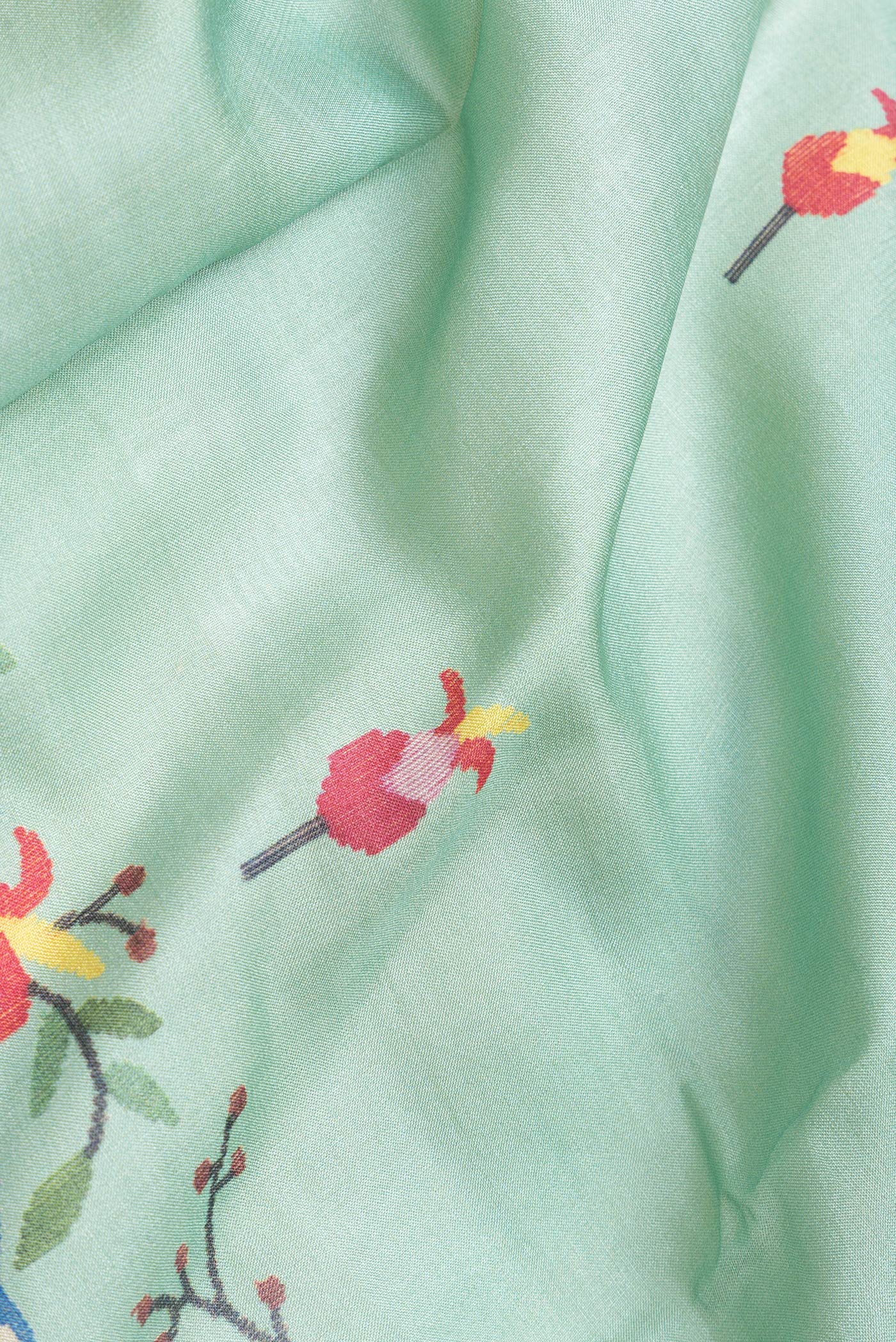 Close up of Sea Green Dual Tone Tussar Silk Saree with Printed design on the body and Zari Border.  displaying folds