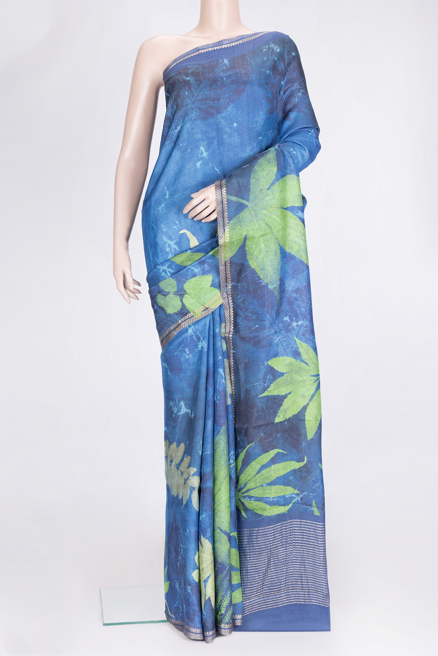 Peacock Blue Dual Tone Tussar Silk Saree with Printed design on the body and Zari Border.  displayed on a mannequin