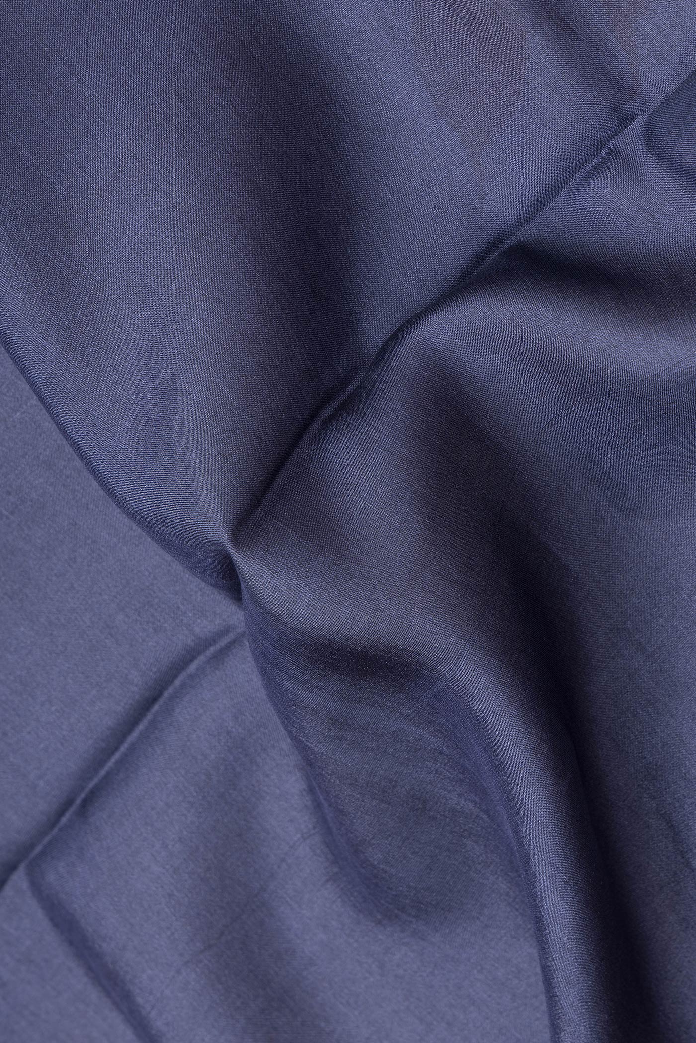 Close up of Navy Blue Dual Tone Tussar Silk Saree with Printed design on the body and Zari Border.  displaying folds
