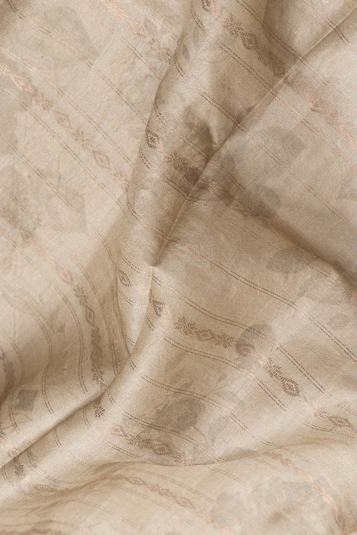 Close up of Beige Dual Tone Tussar Silk Saree with Stripes on the body and Printed Border.  displaying folds