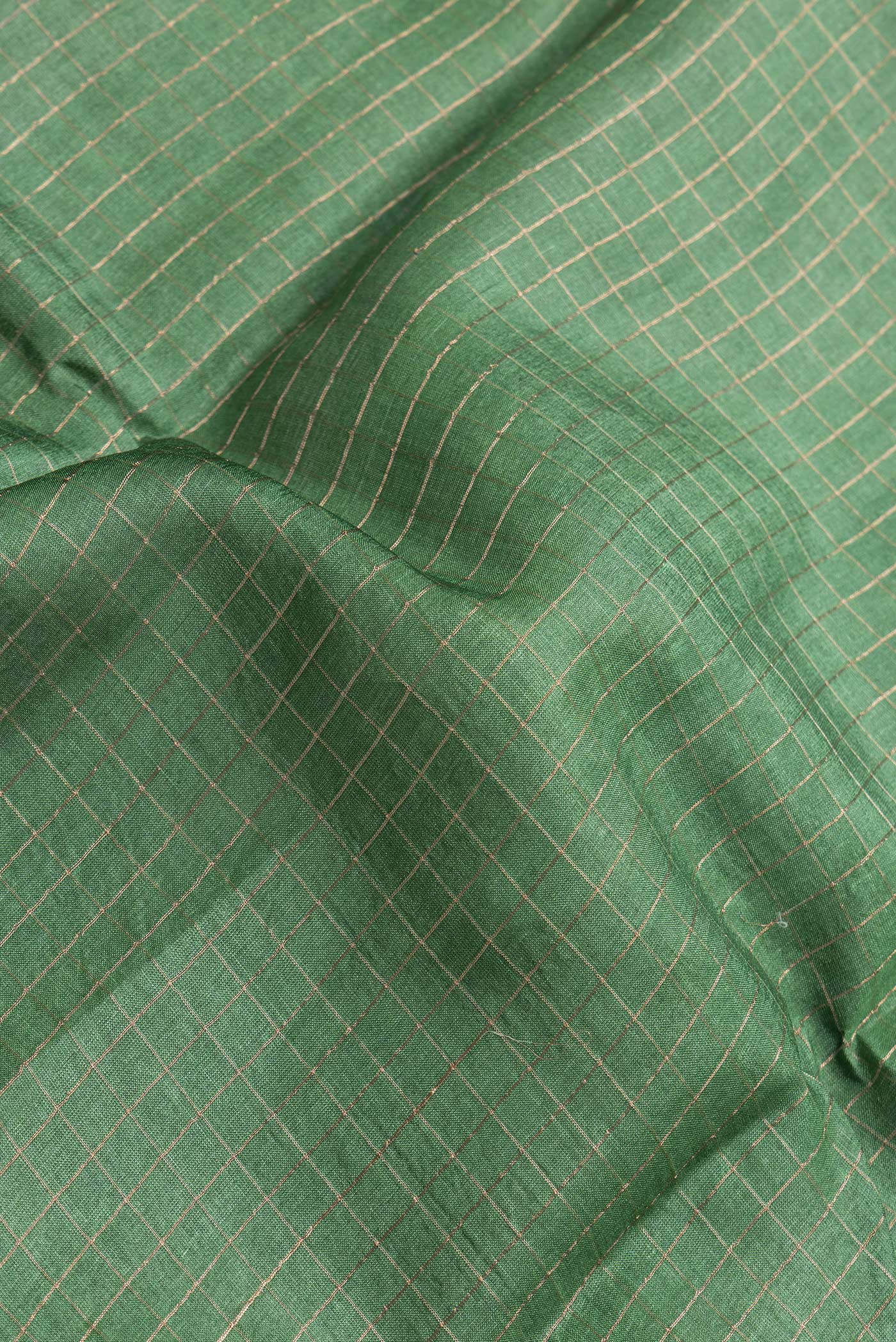 Close up of Bottle Green Dual Tone Tussar Silk Saree with Checked design on the body and Printed Border.  displaying folds