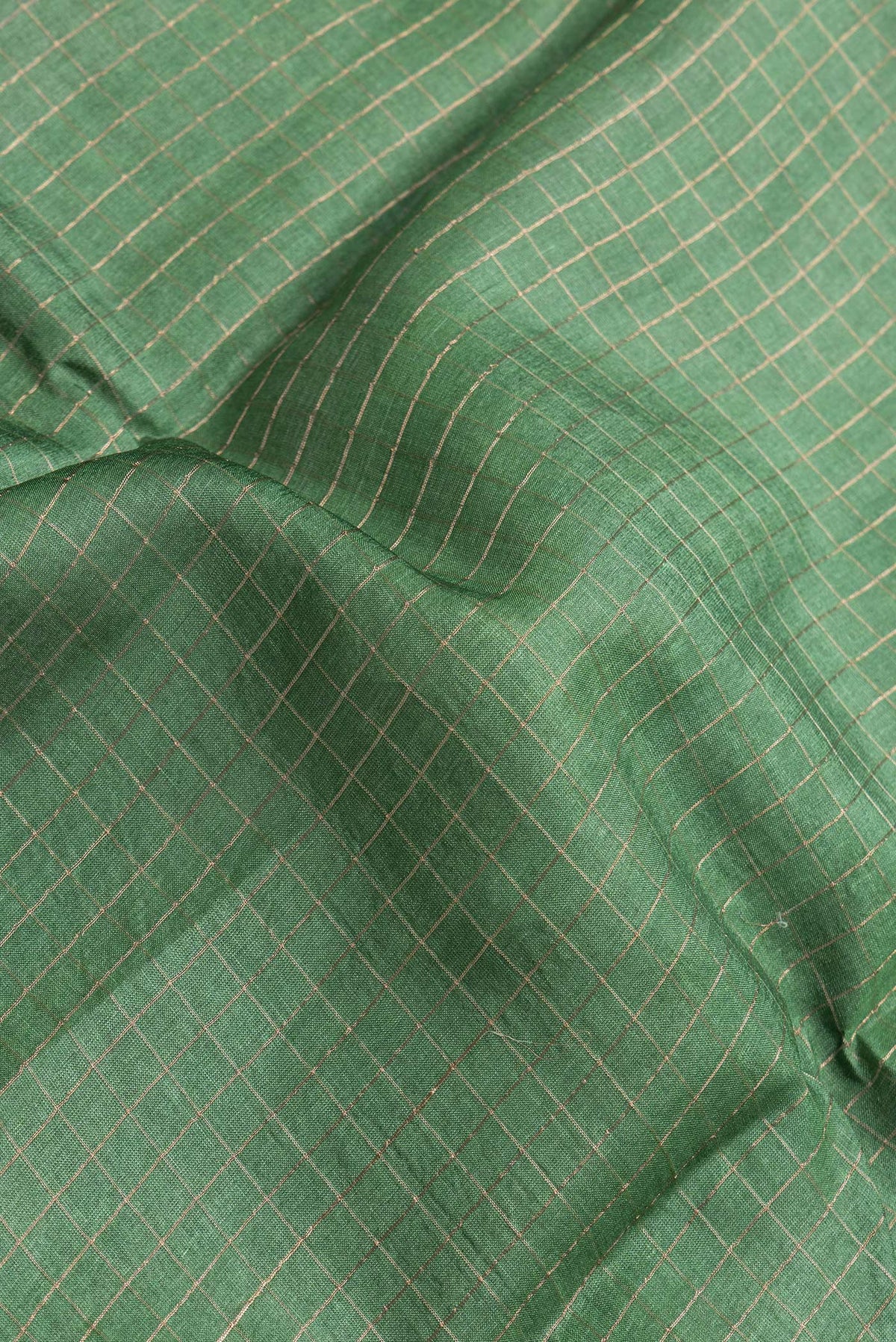 Close up of Bottle Green Dual Tone Tussar Silk Saree with Checked design on the body and Printed Border.  displaying folds