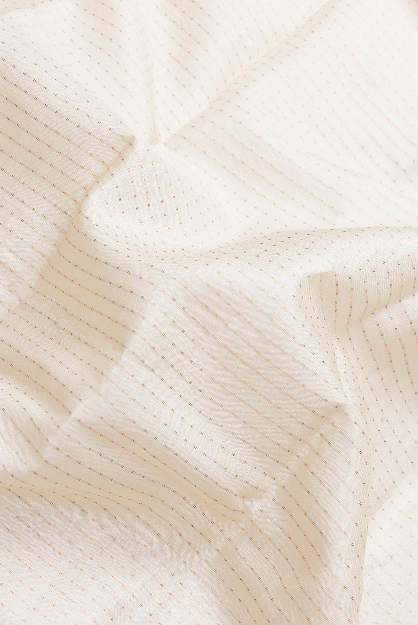 Close up of Off White Dual Tone Tussar Silk Saree with Stripes on the body and Printed Border.  displaying folds