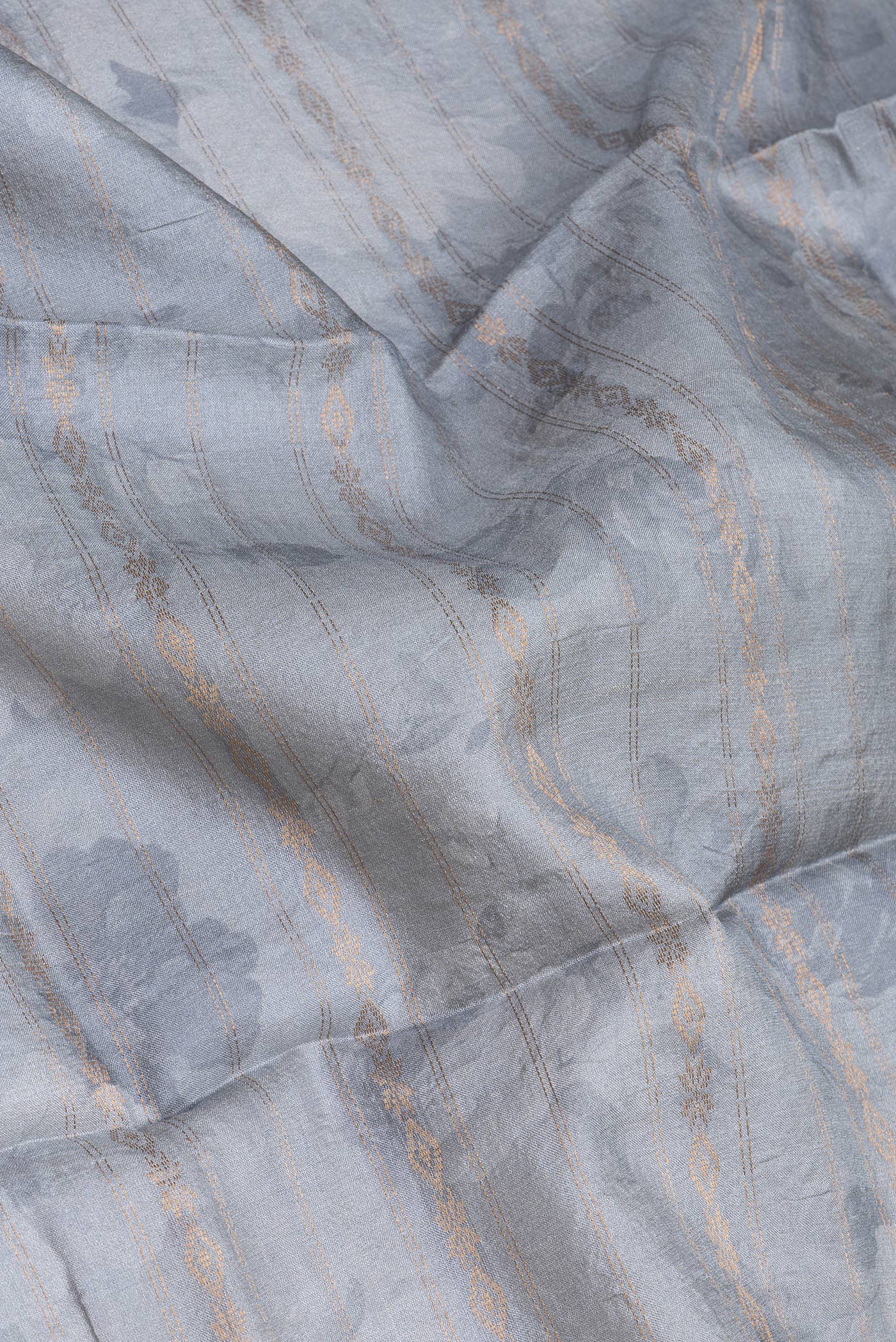 Close up of Grey Tussar Silk Saree with Stripes on the body and Fancy Border.  displaying folds