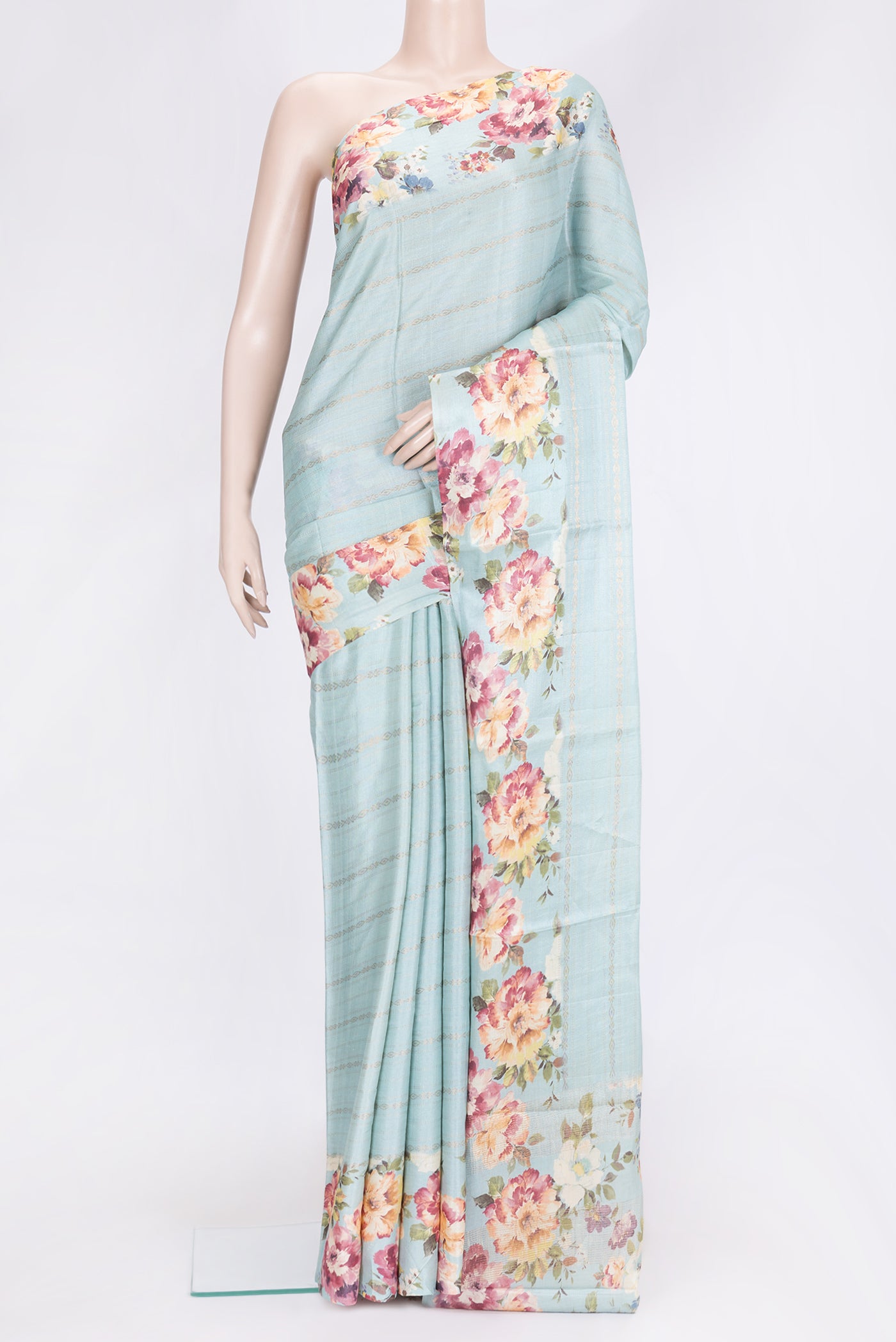 Sky Blue Dual Tone Tussar Silk Saree with Stripes on the body and Printed Border.  displayed on a mannequin