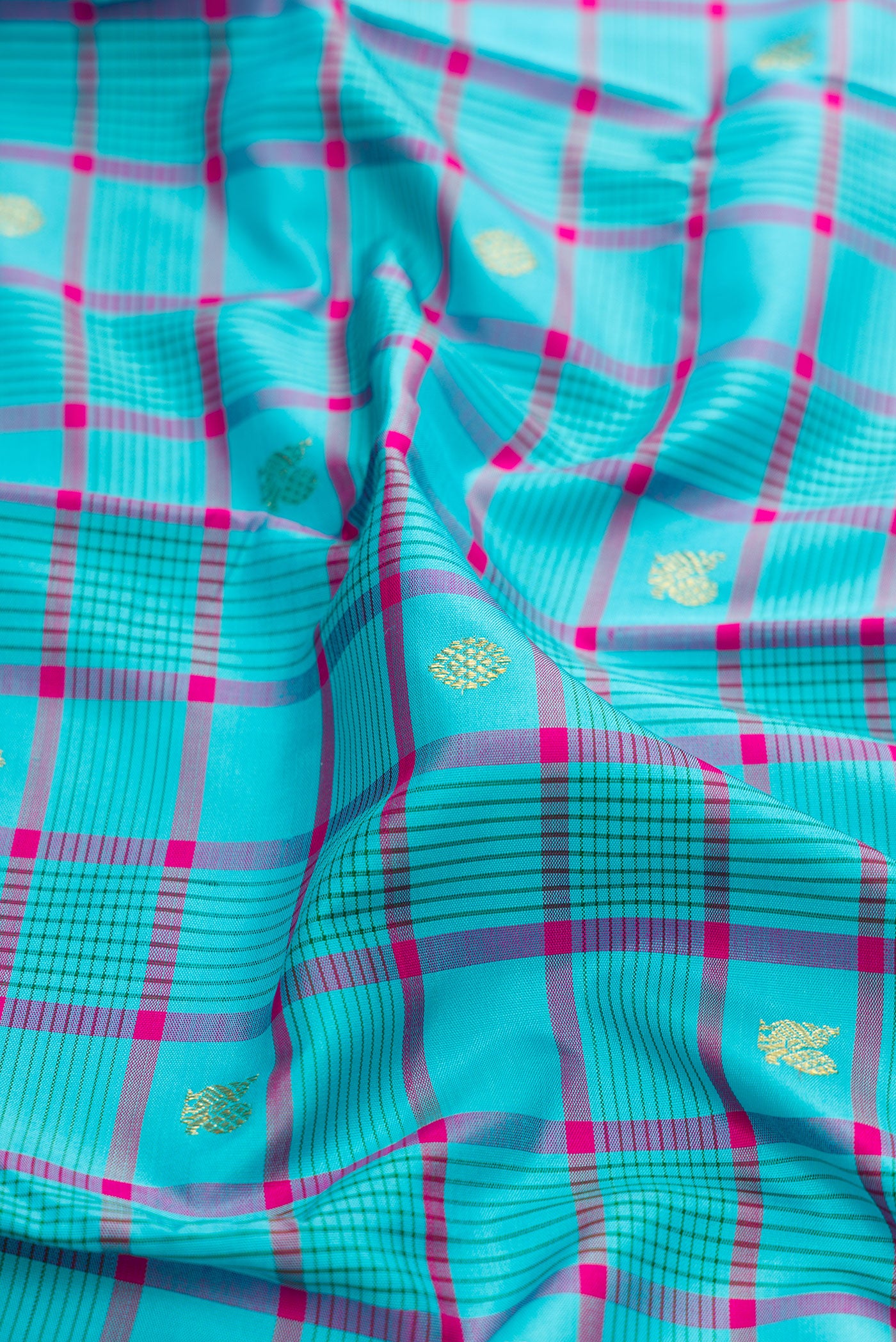 Close up of Sky Blue Kanjivaram Silk Saree with Checked design on the body and Zari Border.  displaying folds