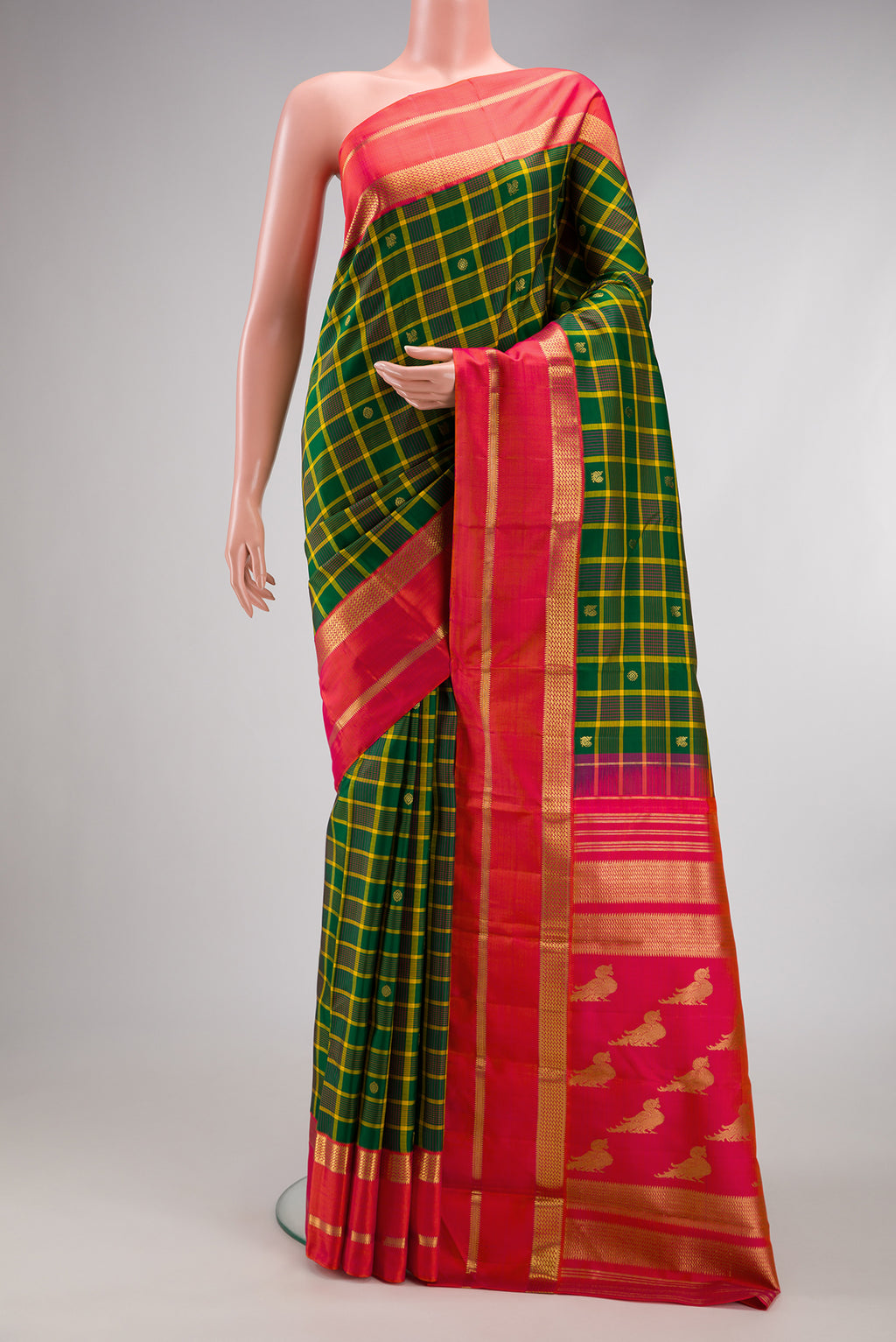Green Kanjivaram Silk Saree with Checked design on the body and Zari Border.  displayed on a mannequin