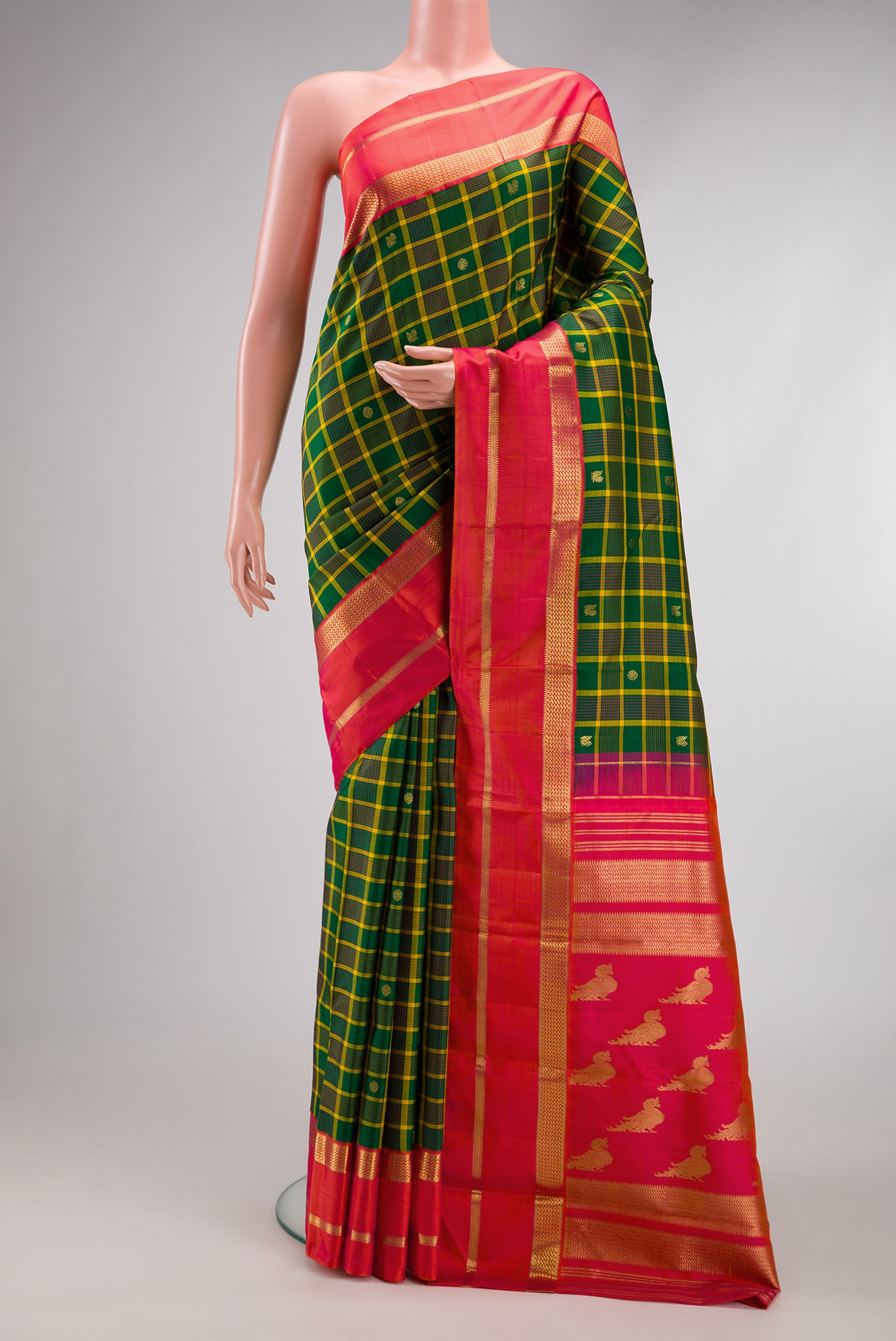 Green Kanjivaram Silk Saree with Checked design on the body and Zari Border.  displayed on a mannequin