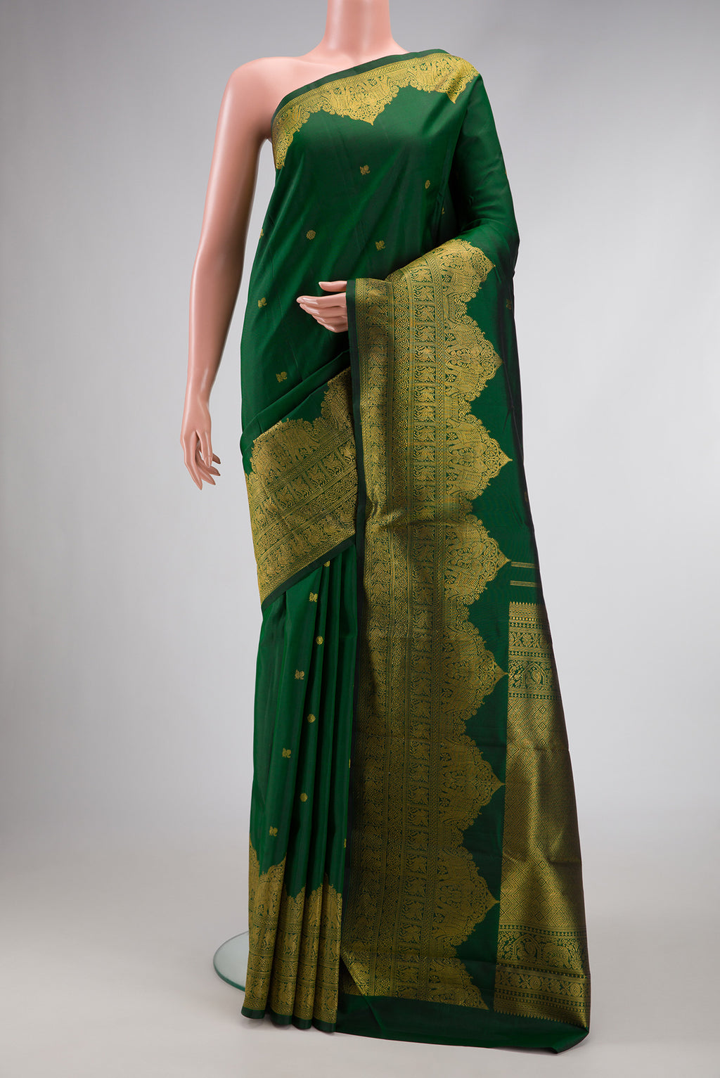 Pure Silk Pure Zari Green Dual Tone Kanjivaram Saree with Zari Butta on the body and Zari Border.  displayed on a mannequin