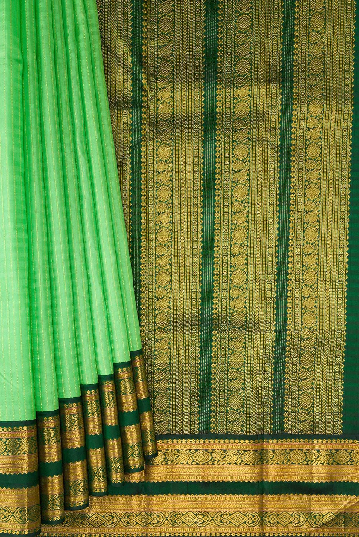 Pleats and pallu of Parrot Green Kanjivaram Silk Saree with Stripes on the body and Ganga Jamuna Border. 
