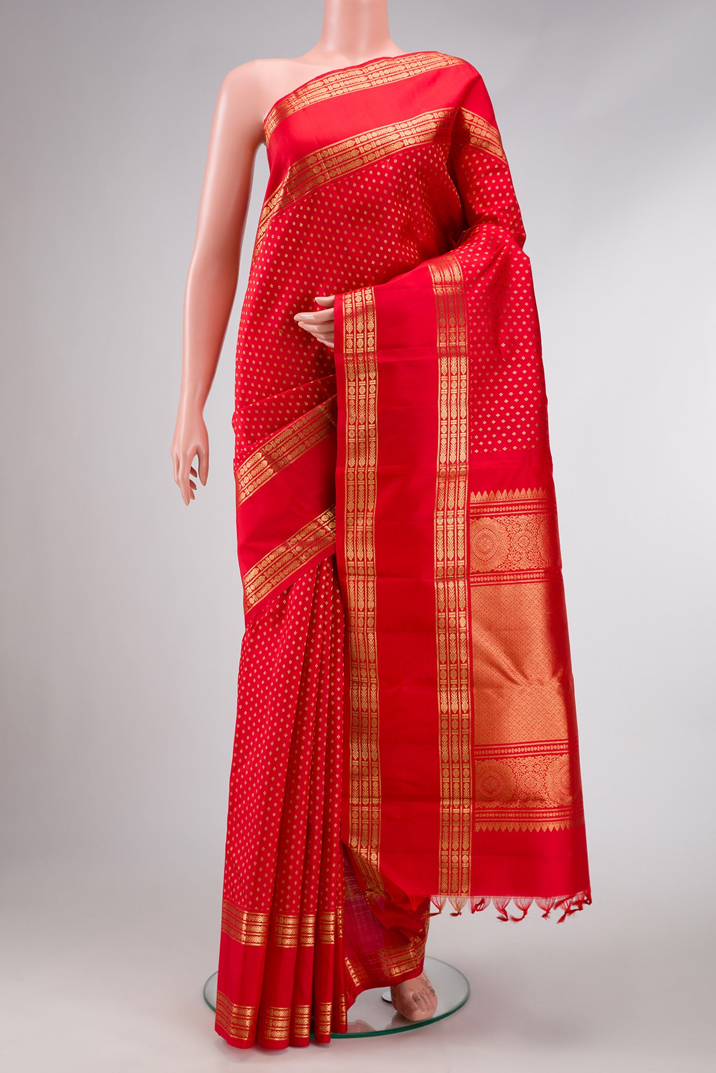 Pure Silk Pure Zari Red Dual Tone Kanjivaram Saree with Zari Butta on the body and Zari Border.  displayed on a mannequin