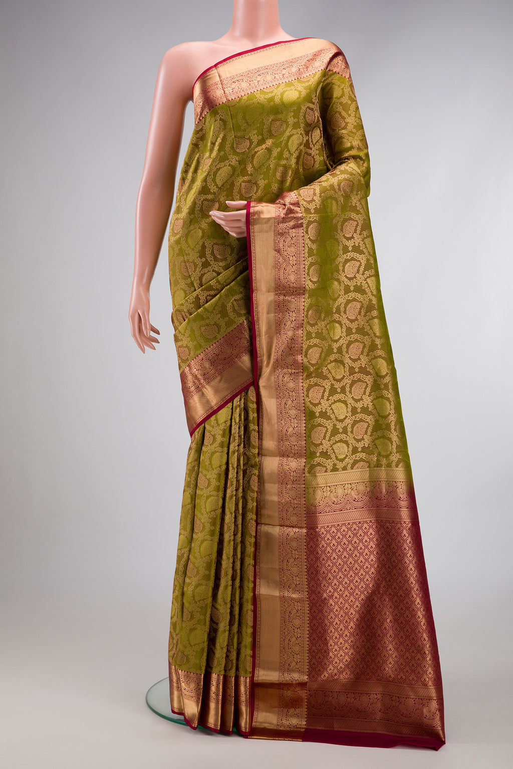 Mehandi Green Dual Tone Kanchipuram Silk Saree with Zari Brocade on the body and Zari Border.  displayed on a mannequin