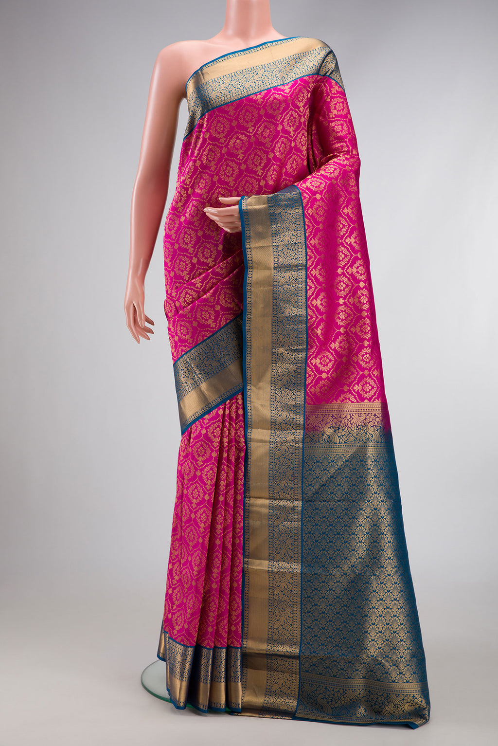 Magenta Dual Tone Kanjivaram Silk Saree with Zari Brocade on the body and Zari Border.  displayed on a mannequin