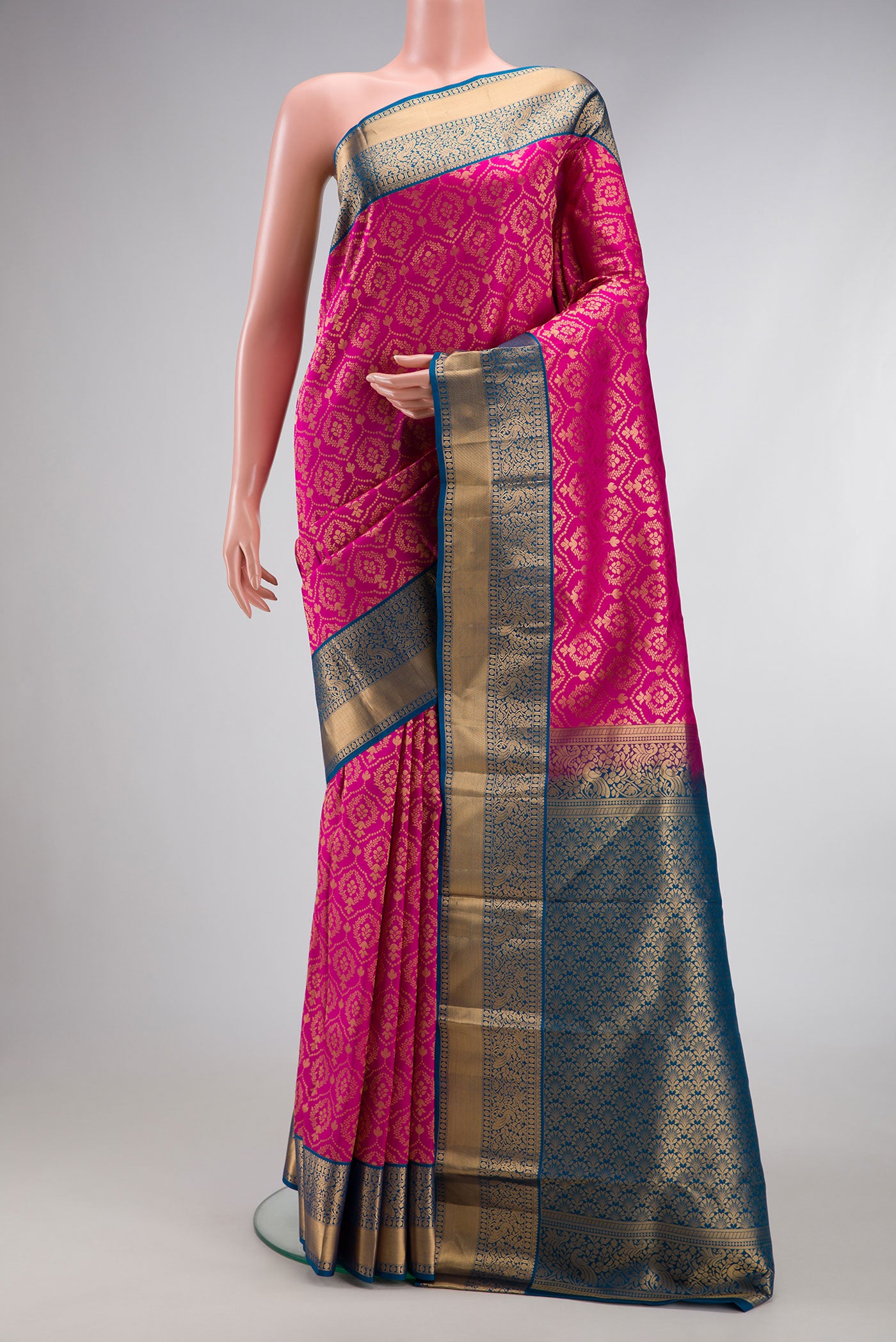 Magenta Dual Tone Kanjivaram Silk Saree with Zari Brocade on the body and Zari Border.  displayed on a mannequin