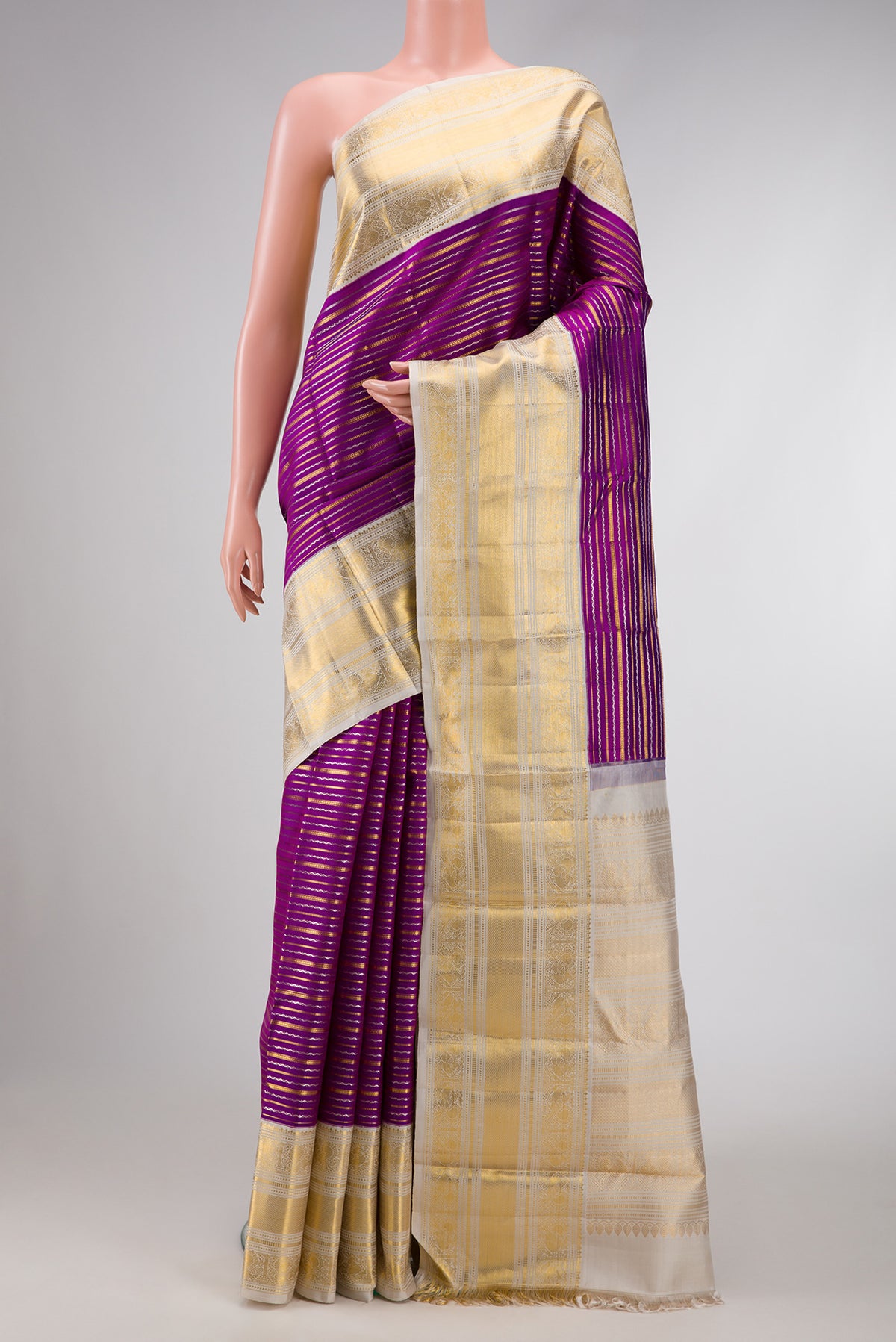 Magenta Dual Tone Kanchipuram Silk Saree with Stripes on the body and Zari Border.  displayed on a mannequin