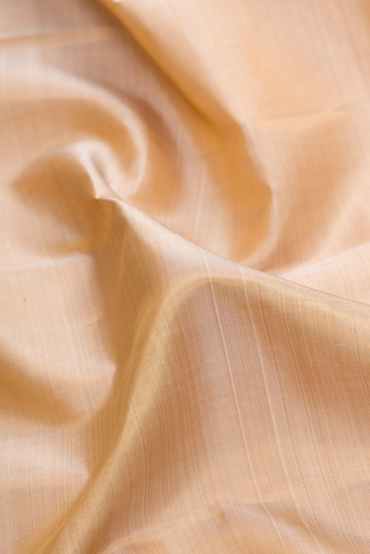 Close up of Pure Silk Pure Zari Beige Dual Tone Kanjivaram Saree with Plain Body and Zari Border.  displaying folds