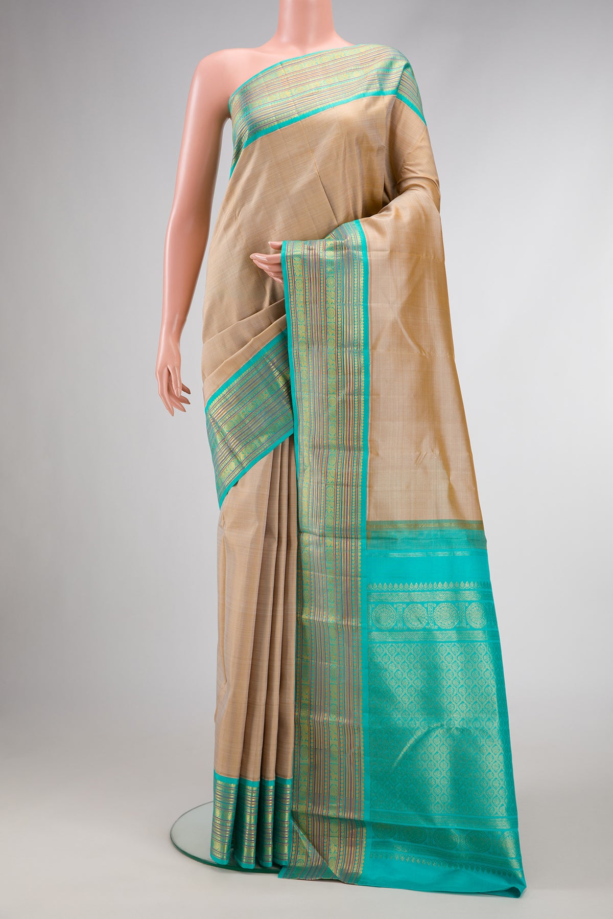 Pure Silk Pure Zari Beige Dual Tone Kanjivaram Saree with Plain Body and Zari Border.  displayed on a mannequin