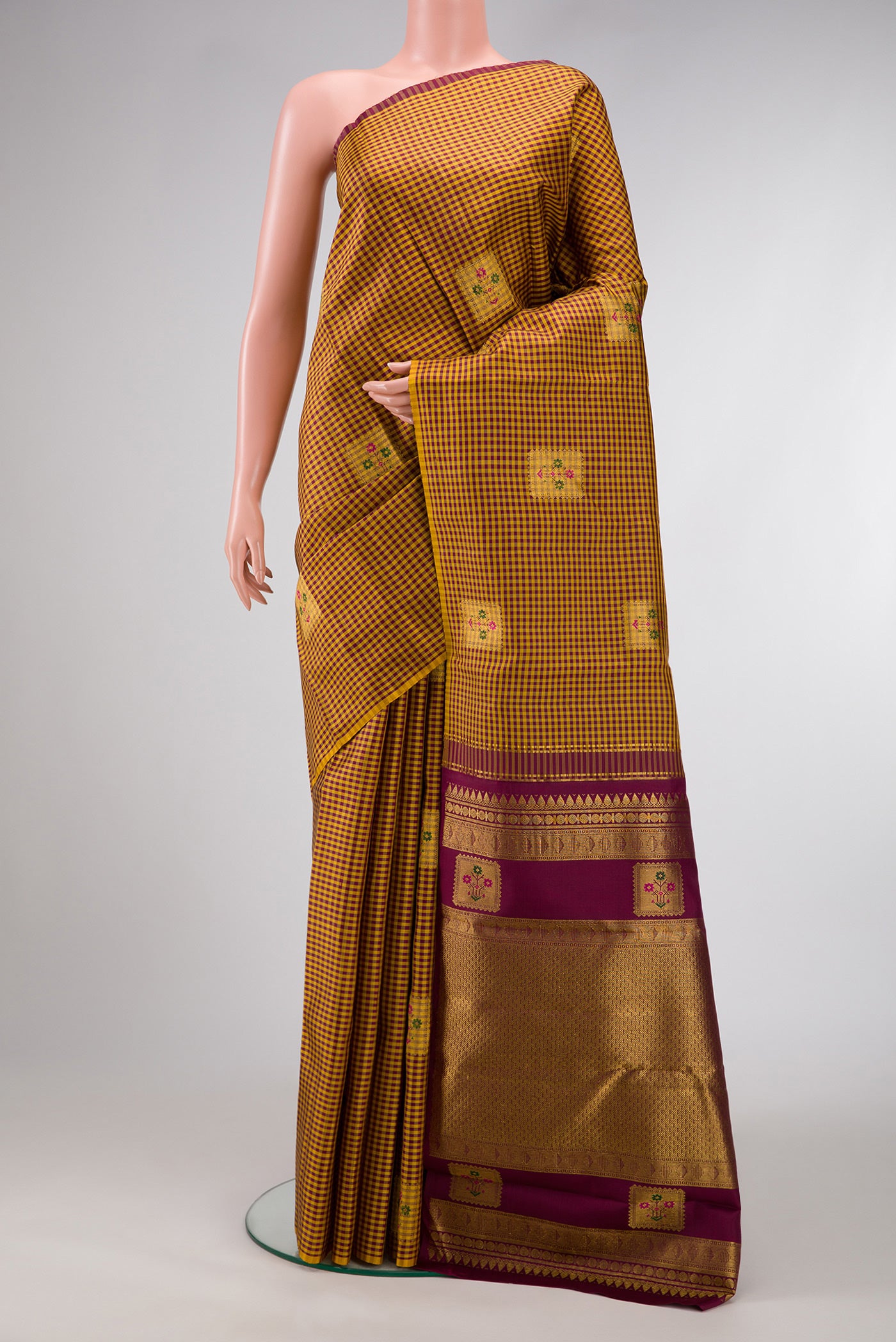 Mustard Dual Tone Kanjivaram Silk Saree with Checked design on the body and Without Border.  displayed on a mannequin