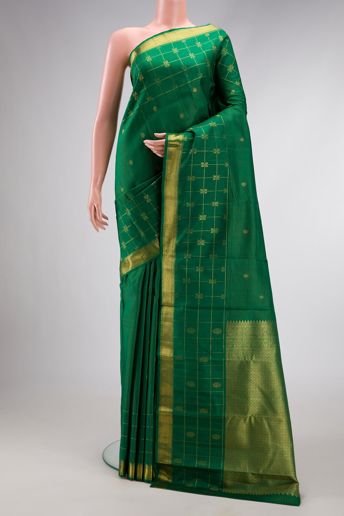 Pure Silk Pure Zari Green Dual Tone Kanjivaram Saree with Zari Butta on the body and Zari Border.  displayed on a mannequin