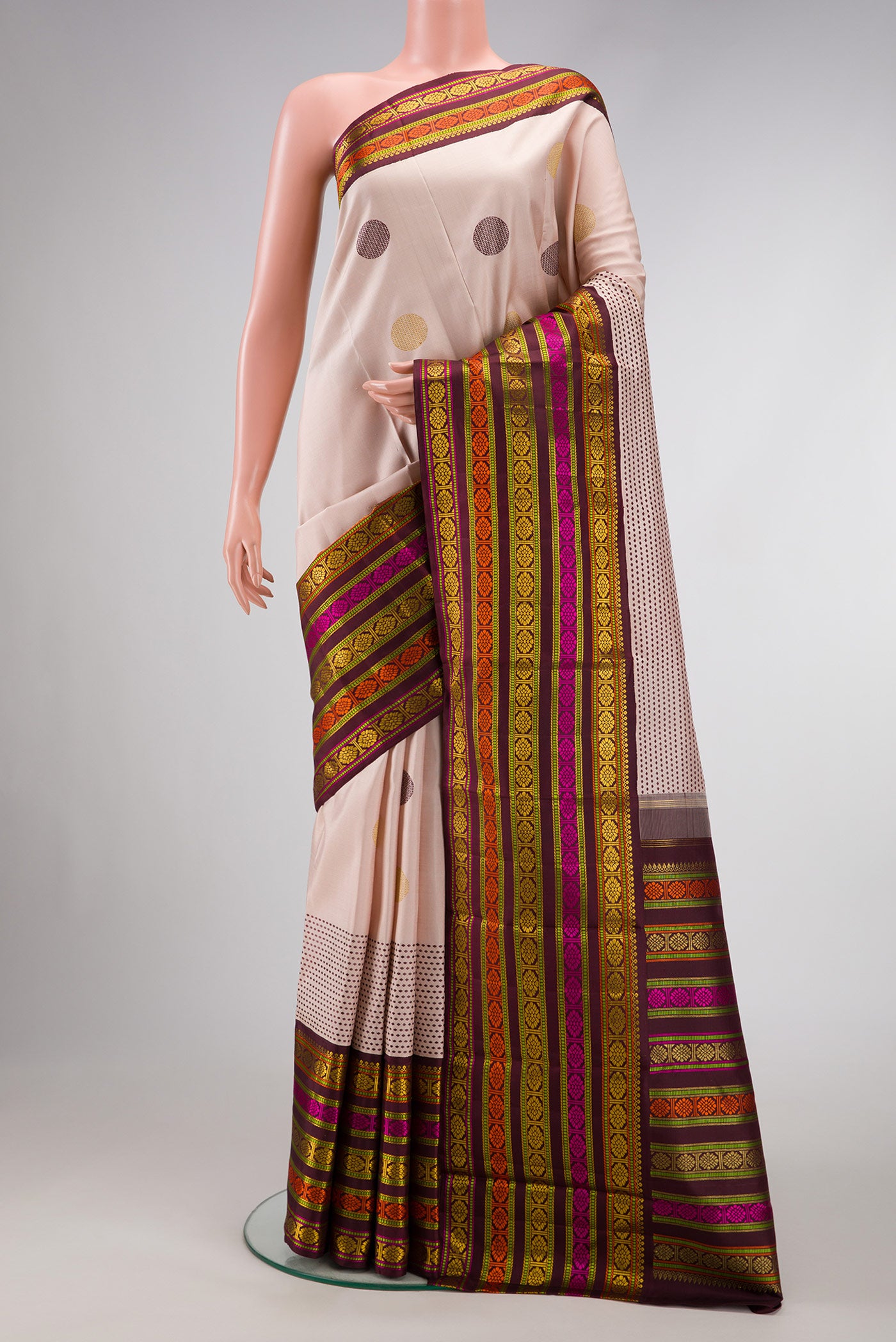 Pure Silk Pure Zari Dark Beige Dual Tone Kanchipuram Saree with Zari And Thread Butta on the body and Zari And Thread Border.  displayed on a mannequin