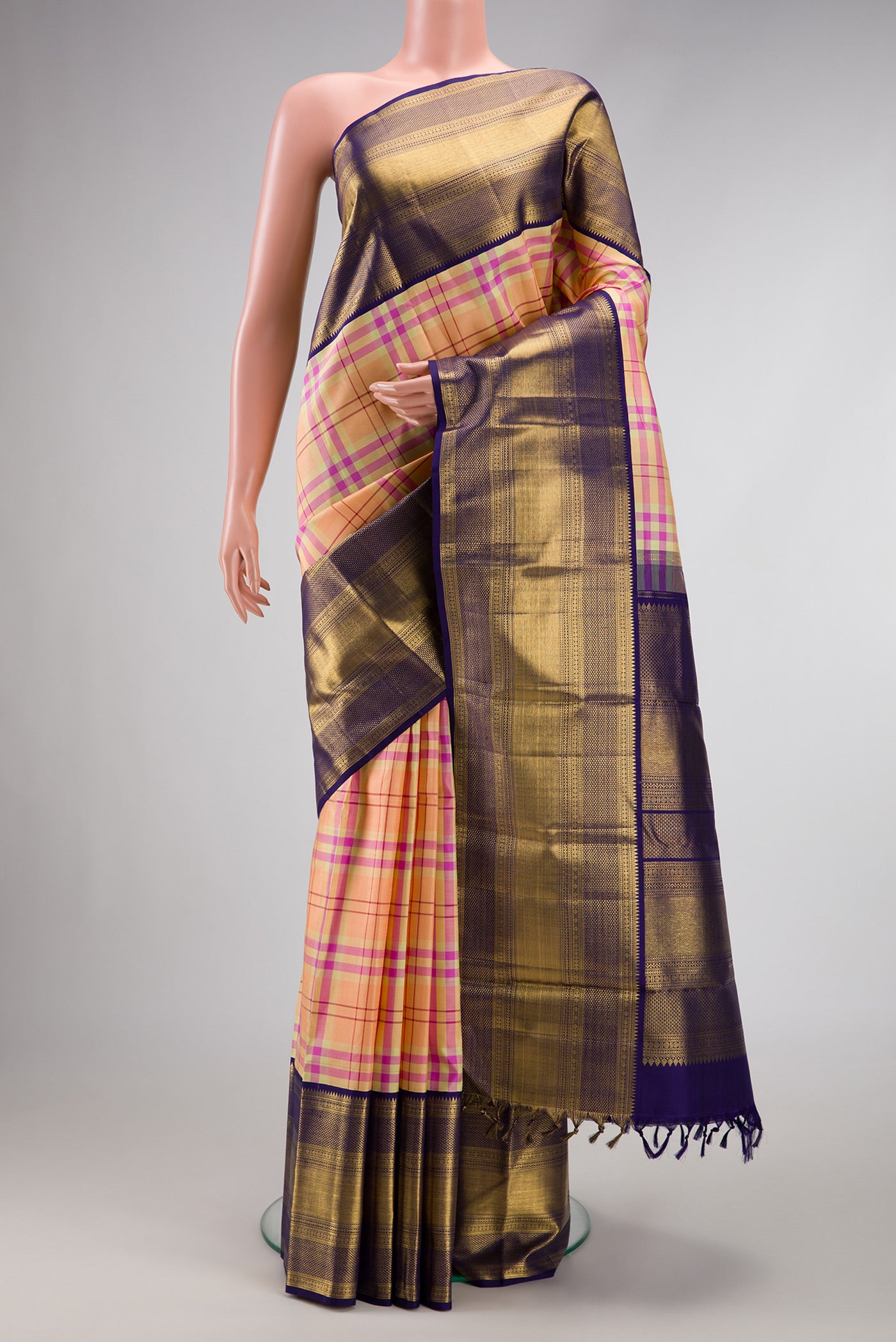 Pure Silk Pure Zari Peach Dual Tone Kanchipuram Saree with Checked design on the body and Zari Border.  displayed on a mannequin