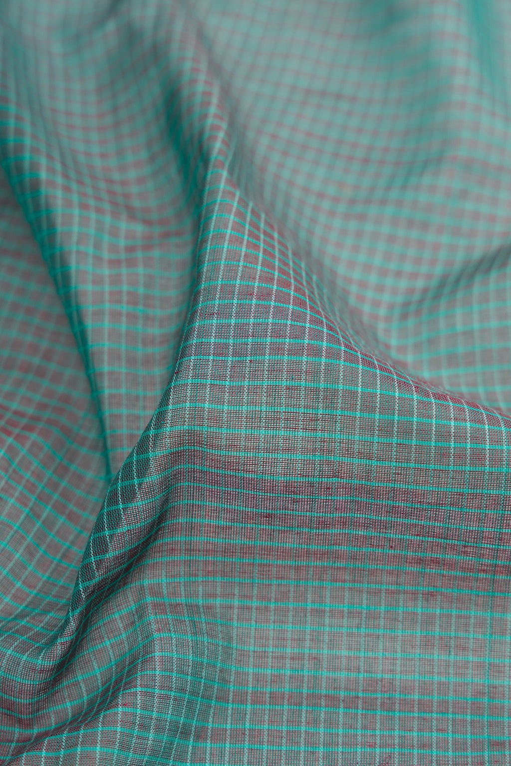 Close up of Purple Gadwal Silk Cotton Saree with Checked design on the body and Zari Border.  displaying folds