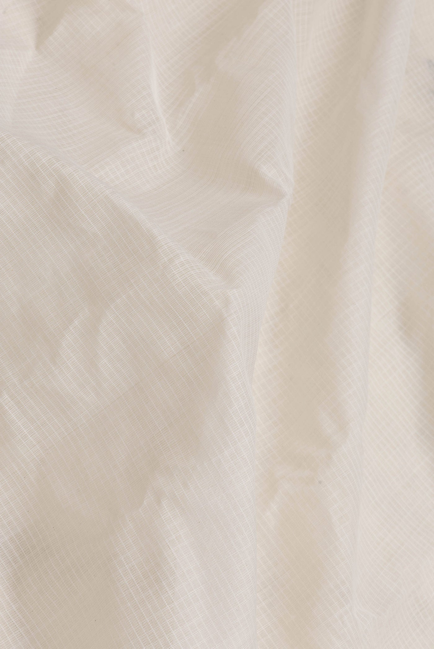 Close up of White Dual Tone Gadwal cotton Saree with Checked design on the body and Zari Border.  displaying folds