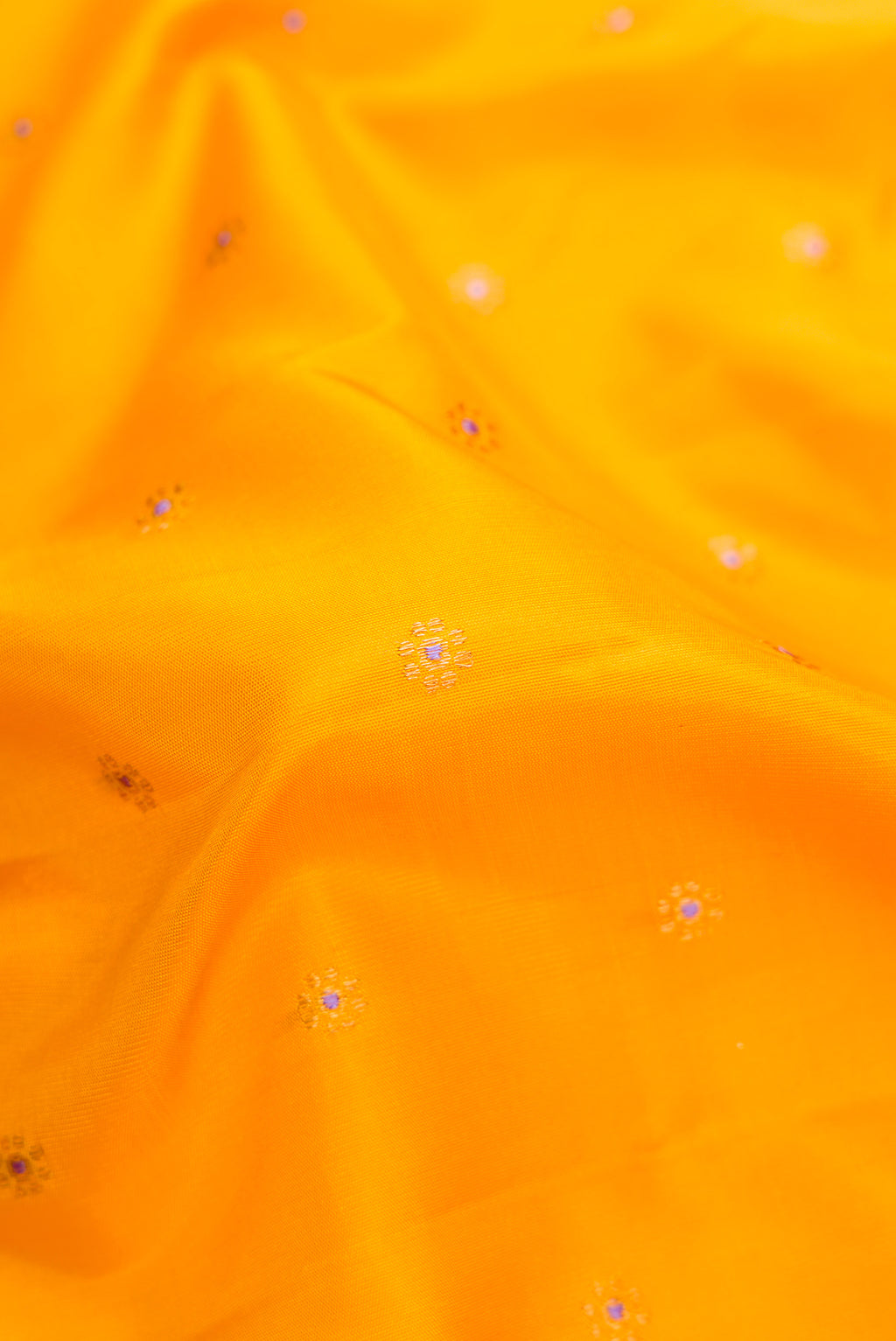 Close up of Yellow Dual Tone Gadwal Silk Saree with Zari And Thread Butta on the body and Temple Border.  displaying folds