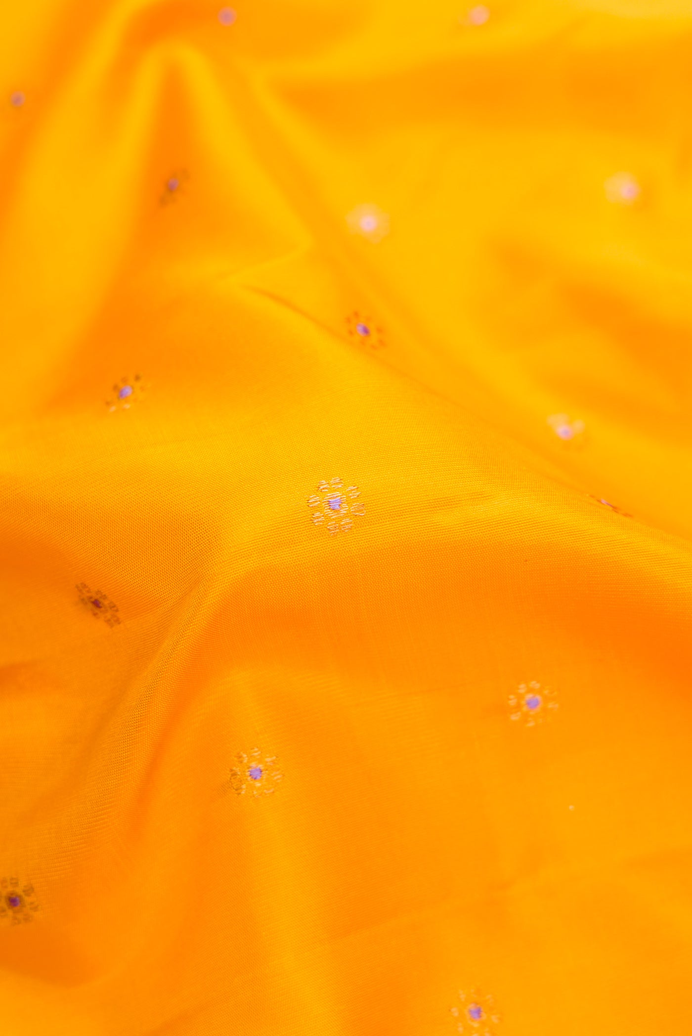 Close up of Yellow Dual Tone Gadwal Silk Saree with Zari And Thread Butta on the body and Temple Border.  displaying folds