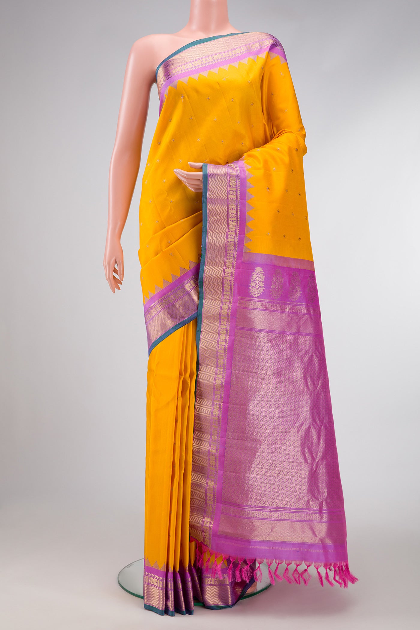 Yellow Dual Tone Gadwal Silk Saree with Zari And Thread Butta on the body and Temple Border.  displayed on a mannequin