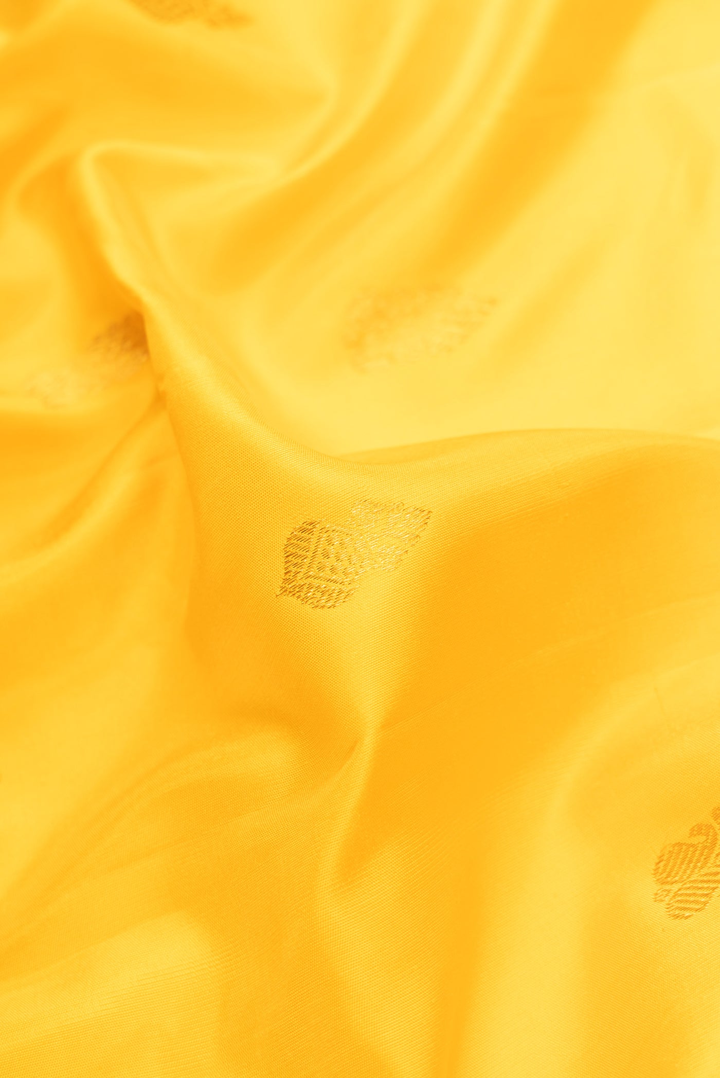 Close up of Yellow Dual Tone Gadwal Silk Saree with Zari Butta on the body and Zari Border.  displaying folds