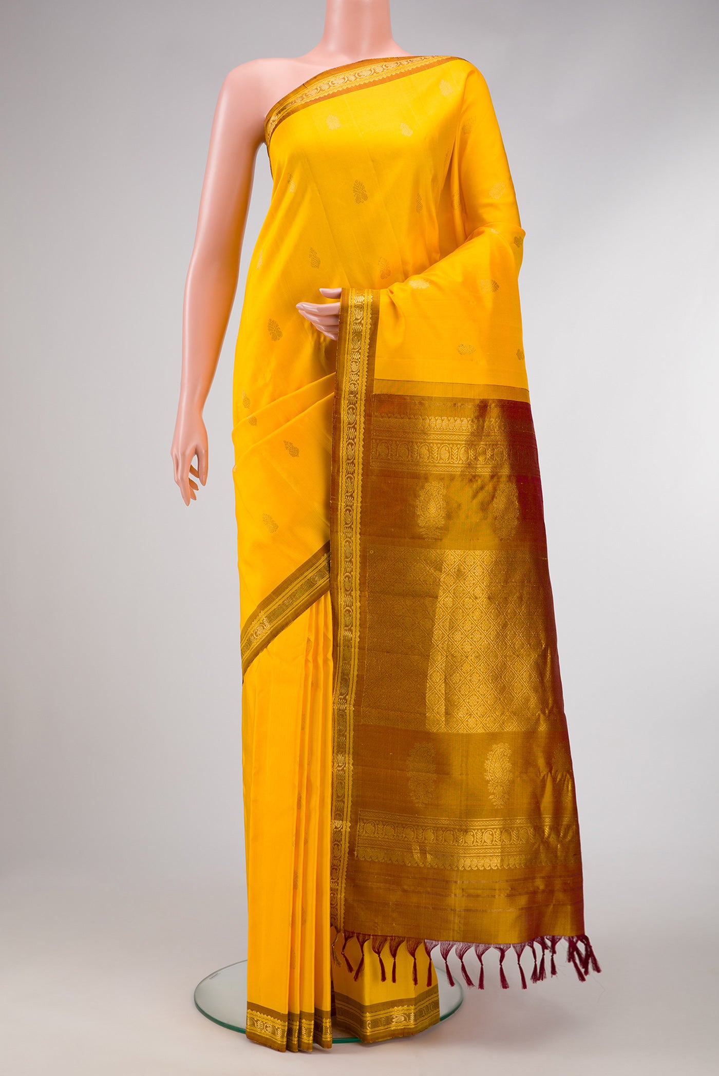 Yellow Dual Tone Gadwal Silk Saree with Zari Butta on the body and Zari Border.  displayed on a mannequin