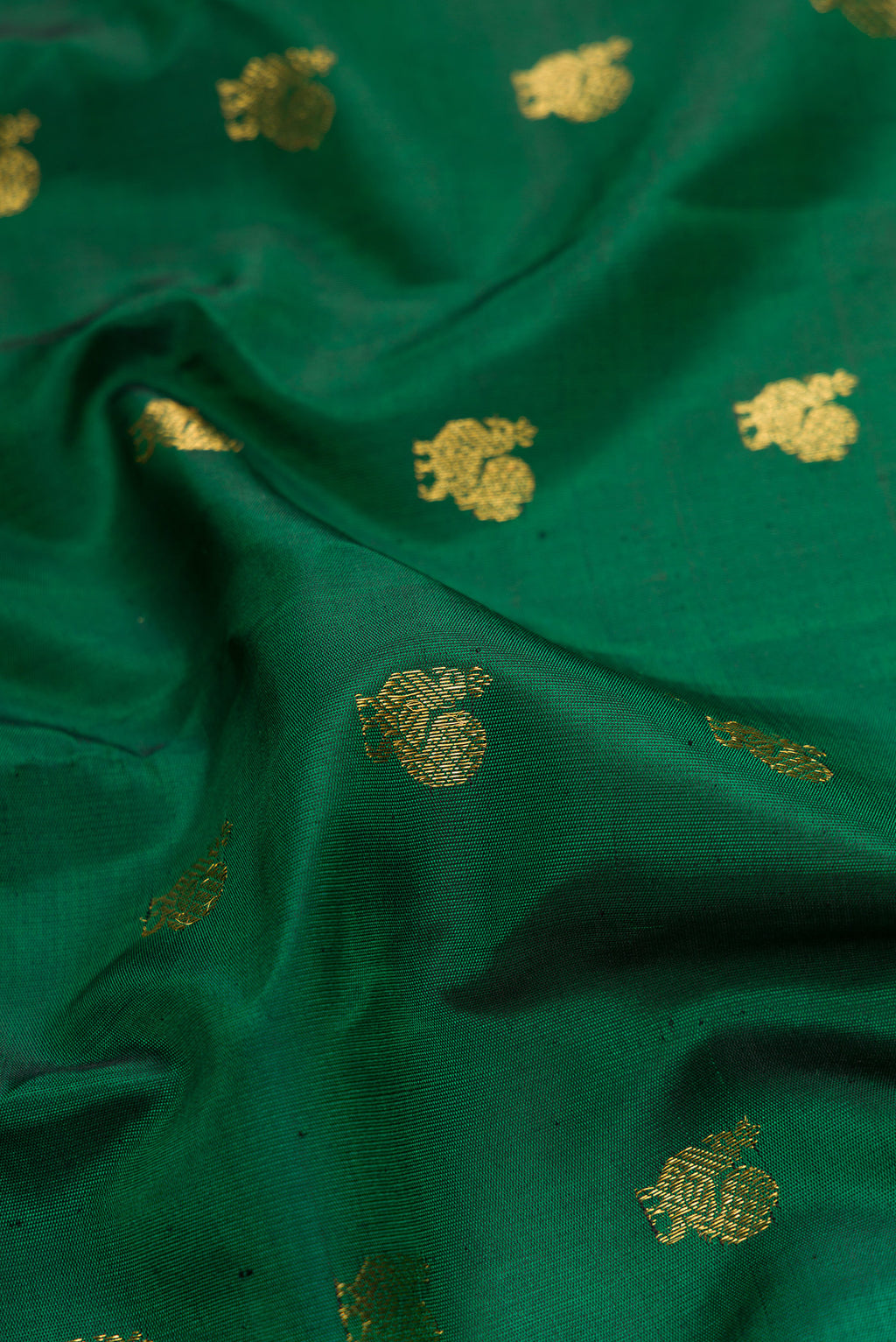 Close up of Bottle Green Dual Tone Gadwal Silk Saree with Zari Butta on the body and Zari Border.  displaying folds