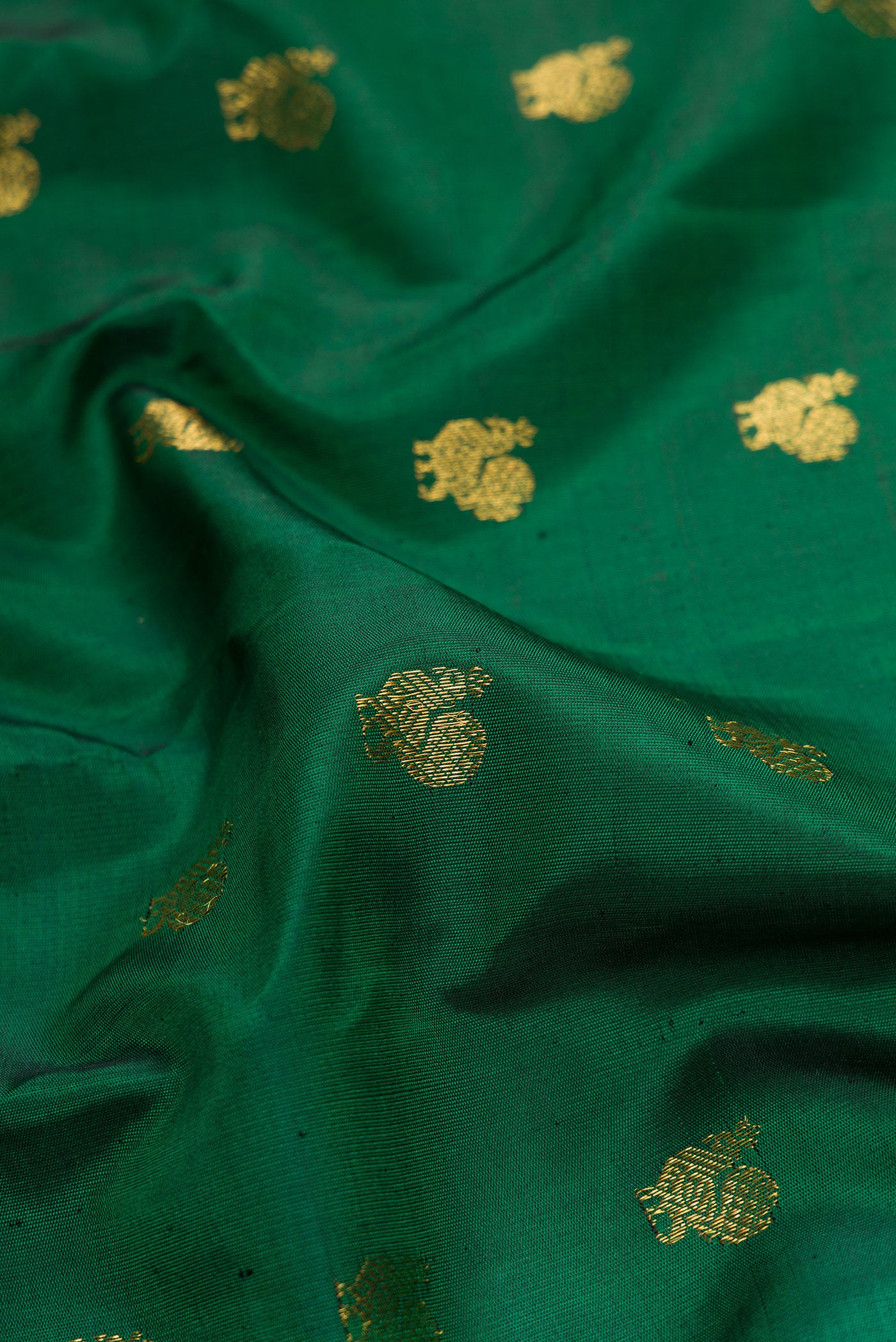 Close up of Bottle Green Dual Tone Gadwal Silk Saree with Zari Butta on the body and Zari Border.  displaying folds