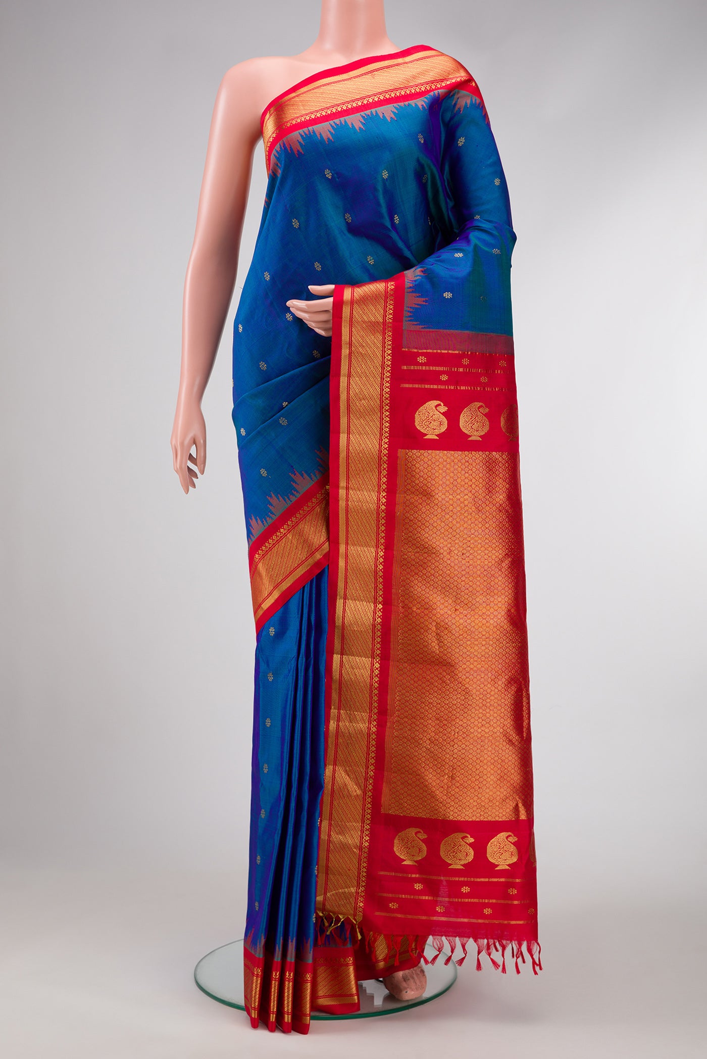 Peacock Blue Dual Tone Gadwal Silk Saree with Zari Butta on the body and Zari Border.  displayed on a mannequin