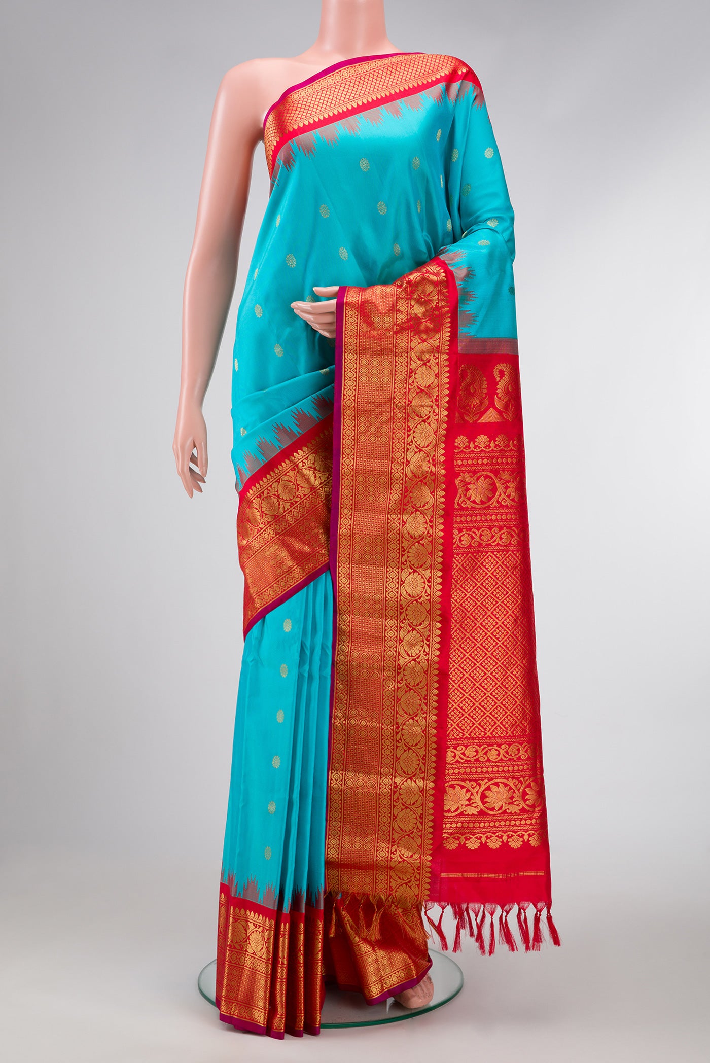 Sky Blue Dual Tone Gadwal Silk Saree with Zari Butta on the body and Temple Border.  displayed on a mannequin