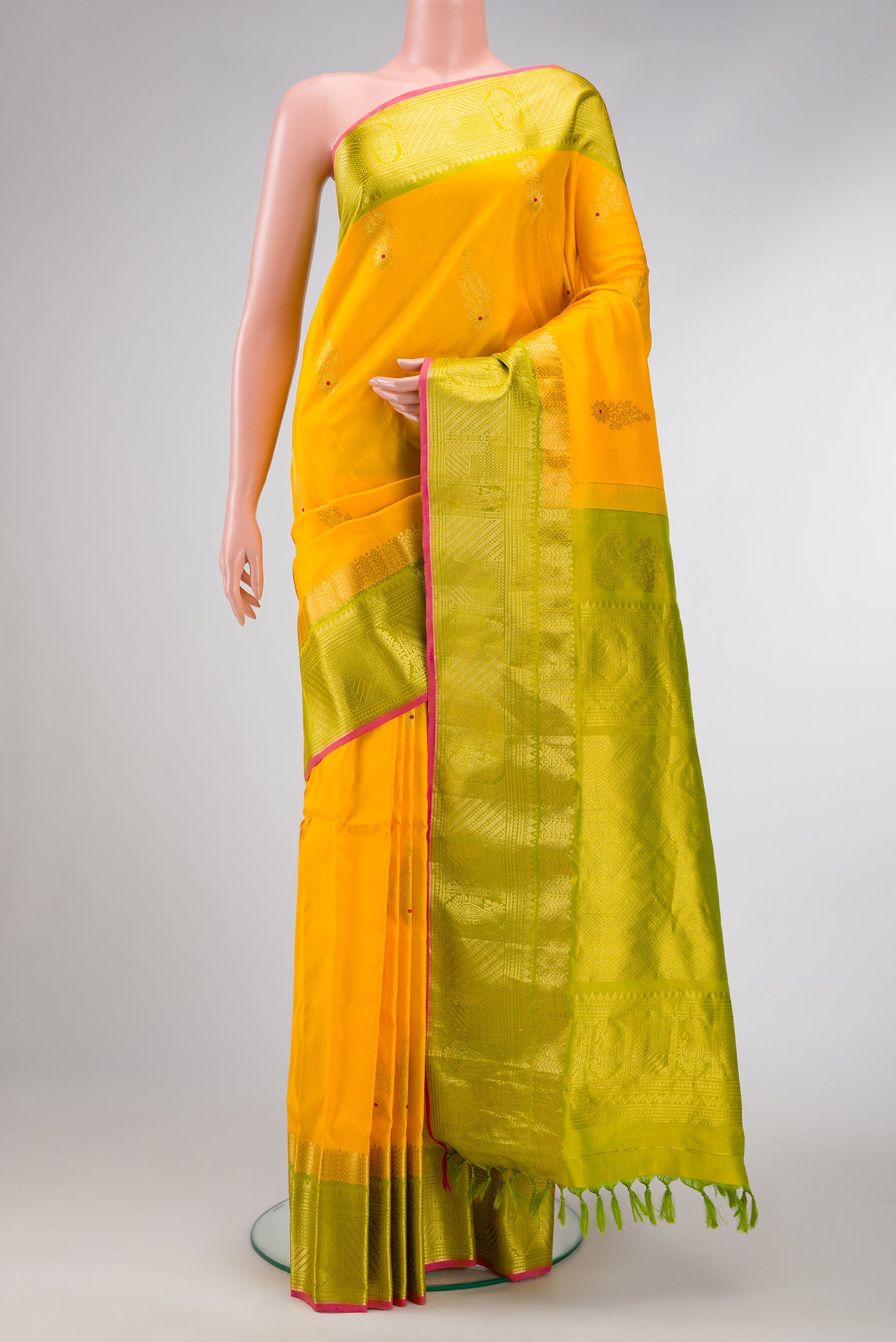 Yellow Dual Tone Gadwal Silk Saree with Zari And Thread Butta on the body and Zari Border.  displayed on a mannequin