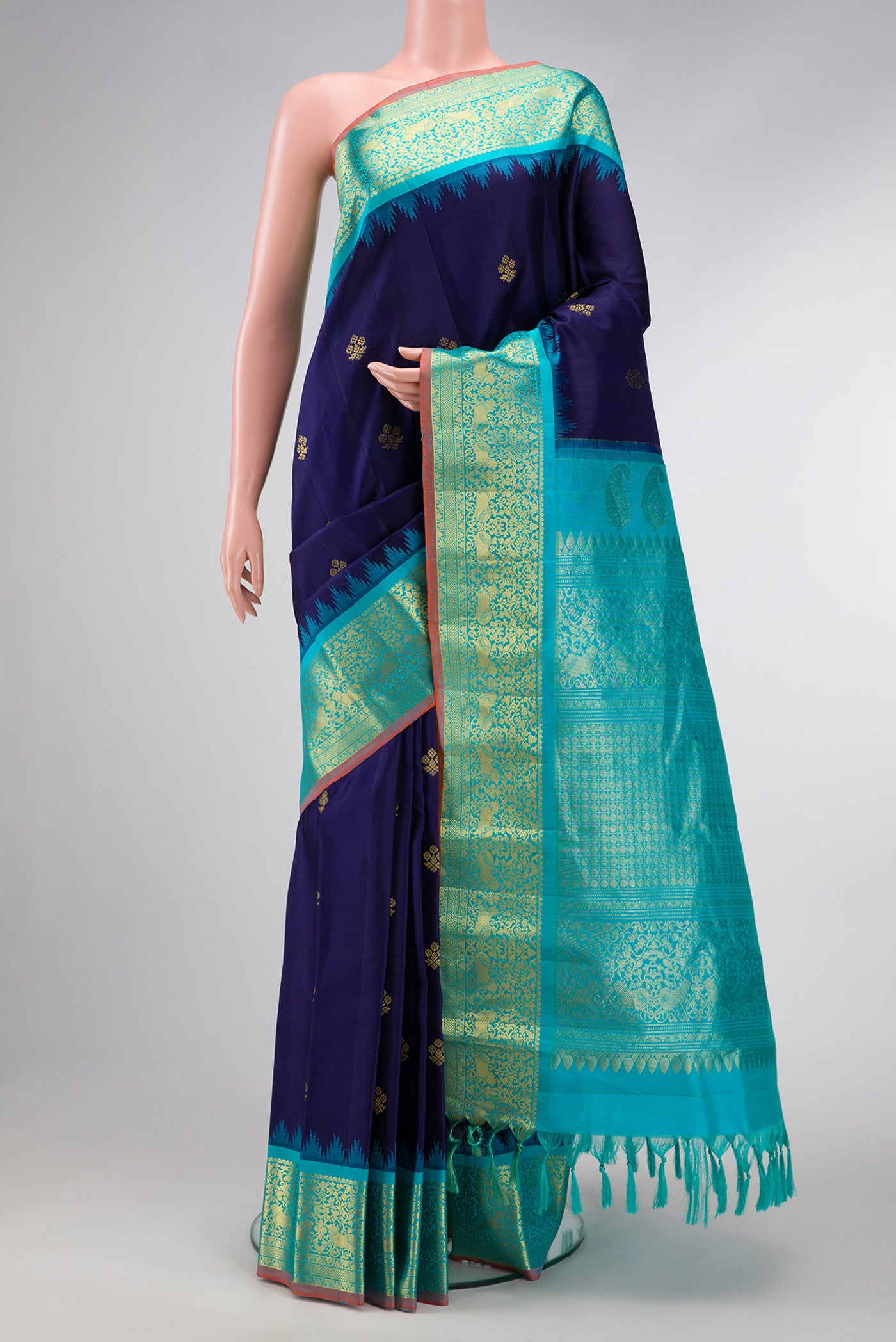 Navy Blue Dual Tone Gadwal Silk Saree with Zari Butta on the body and Temple Border.  displayed on a mannequin