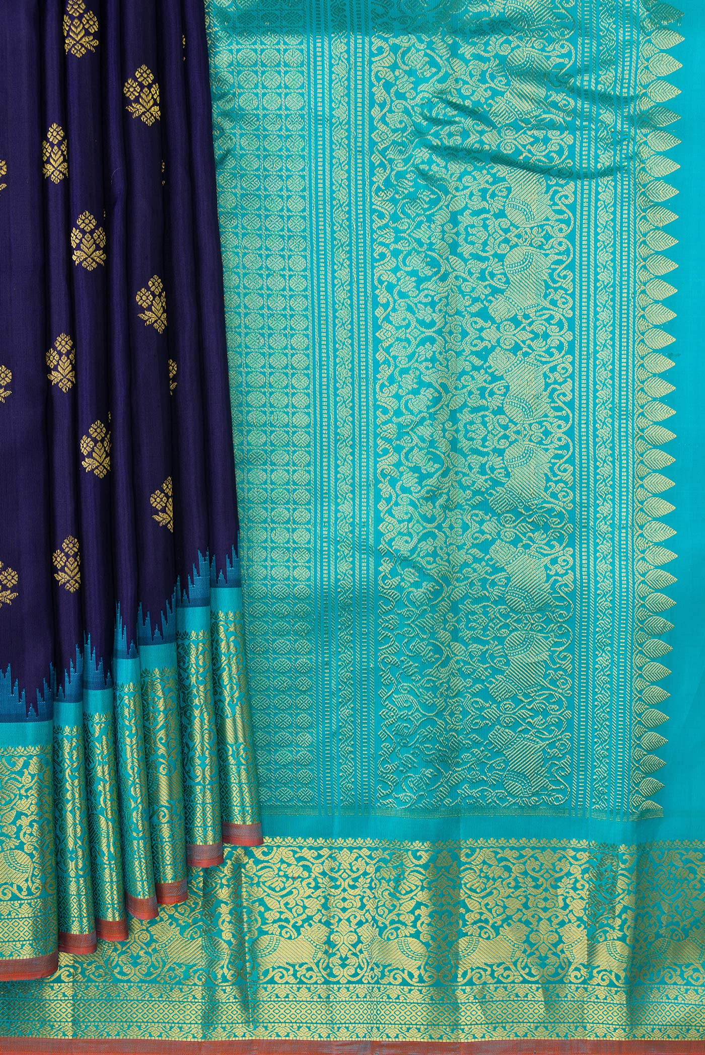 Pleats and pallu of Navy Blue Dual Tone Gadwal Silk Saree with Zari Butta on the body and Temple Border. 
