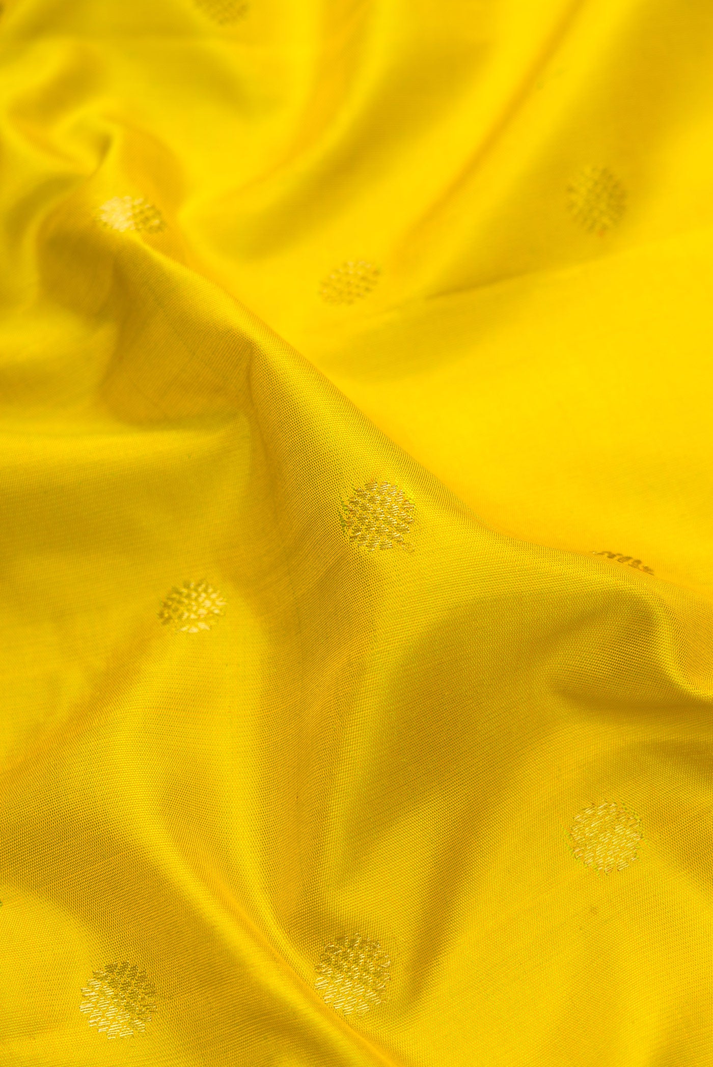 Close up of Parrot Green Dual Tone Gadwal Silk Saree with Zari Butta on the body and Temple Border.  displaying folds
