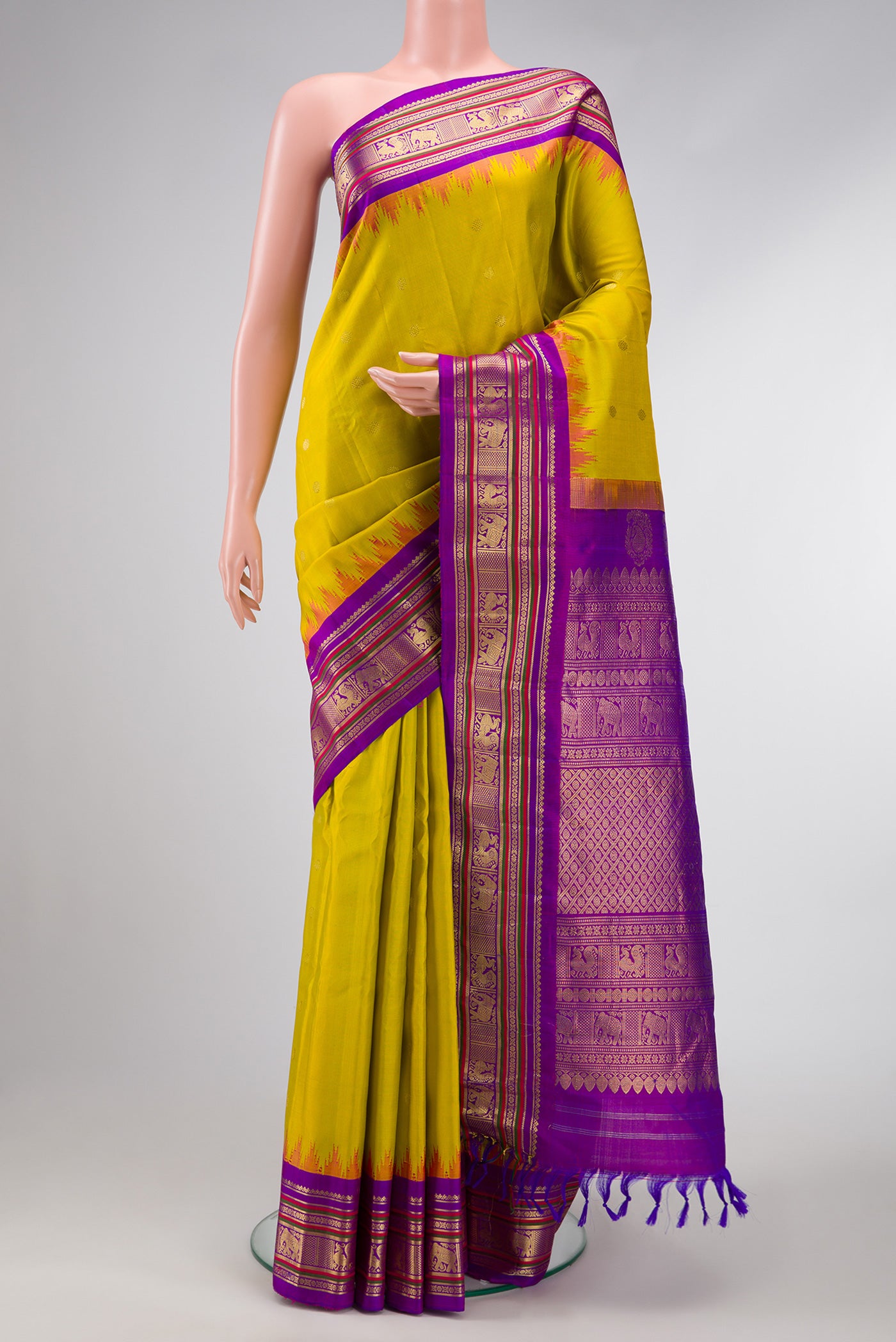 Parrot Green Dual Tone Gadwal Silk Saree with Zari Butta on the body and Temple Border.  displayed on a mannequin