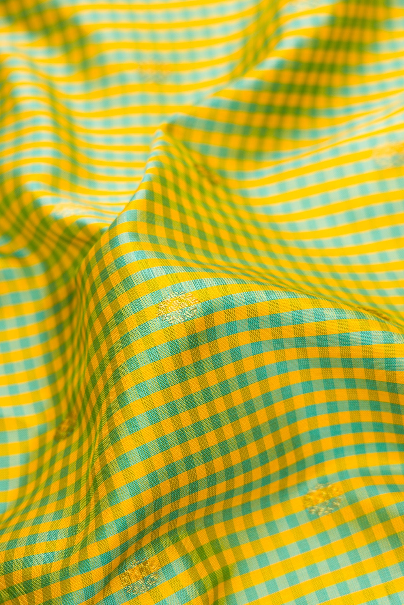Close up of Sky Blue and Yellow Color Gadwal Silk Saree with Checked design on the body and Temple Border.  displaying folds