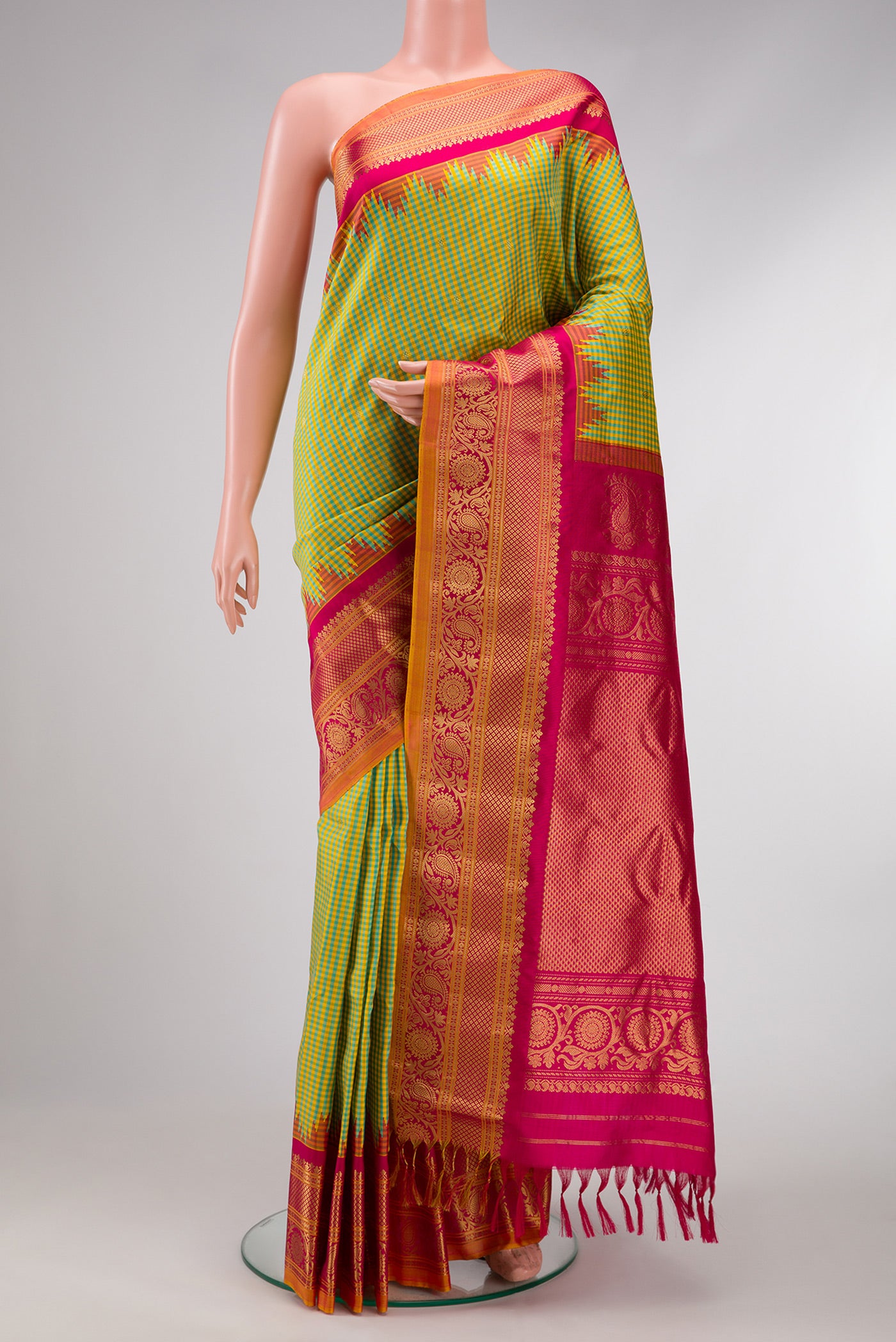 Sky Blue and Yellow Color Gadwal Silk Saree with Checked design on the body and Temple Border.  displayed on a mannequin