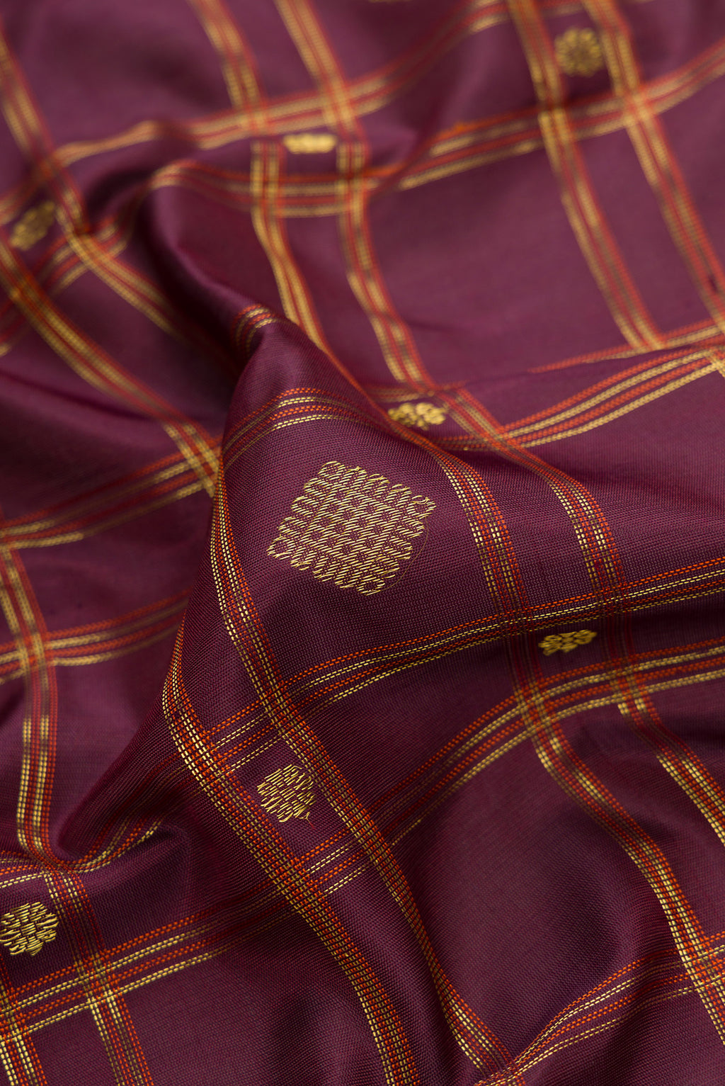 Close up of Burgundy Dual Tone Gadwal Silk Saree with Checked design on the body and Zari Border.  displaying folds
