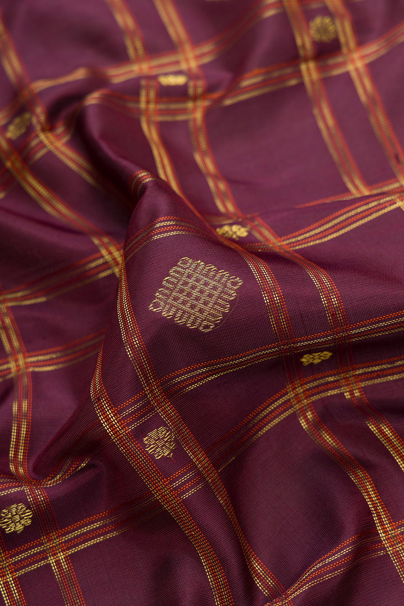 Close up of Burgundy Dual Tone Gadwal Silk Saree with Checked design on the body and Zari Border.  displaying folds