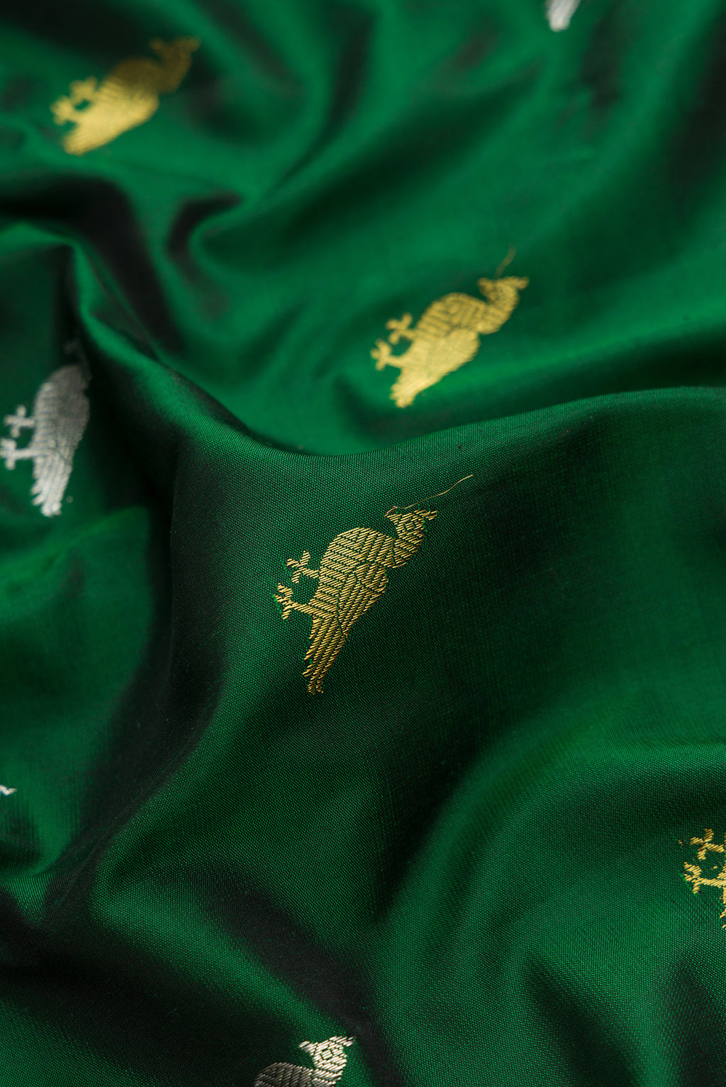 Close up of Bottle Green Dual Tone Gadwal Silk Saree with Zari Butta on the body and Zari Border.  displaying folds