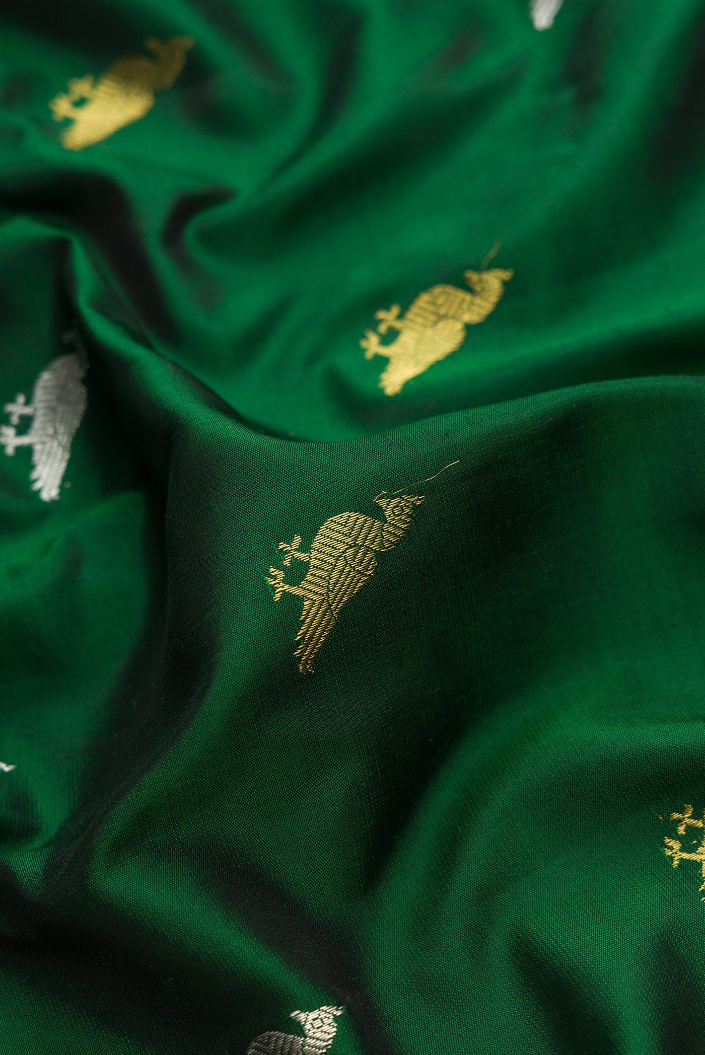 Close up of Bottle Green Dual Tone Gadwal Silk Saree with Zari Butta on the body and Zari Border.  displaying folds