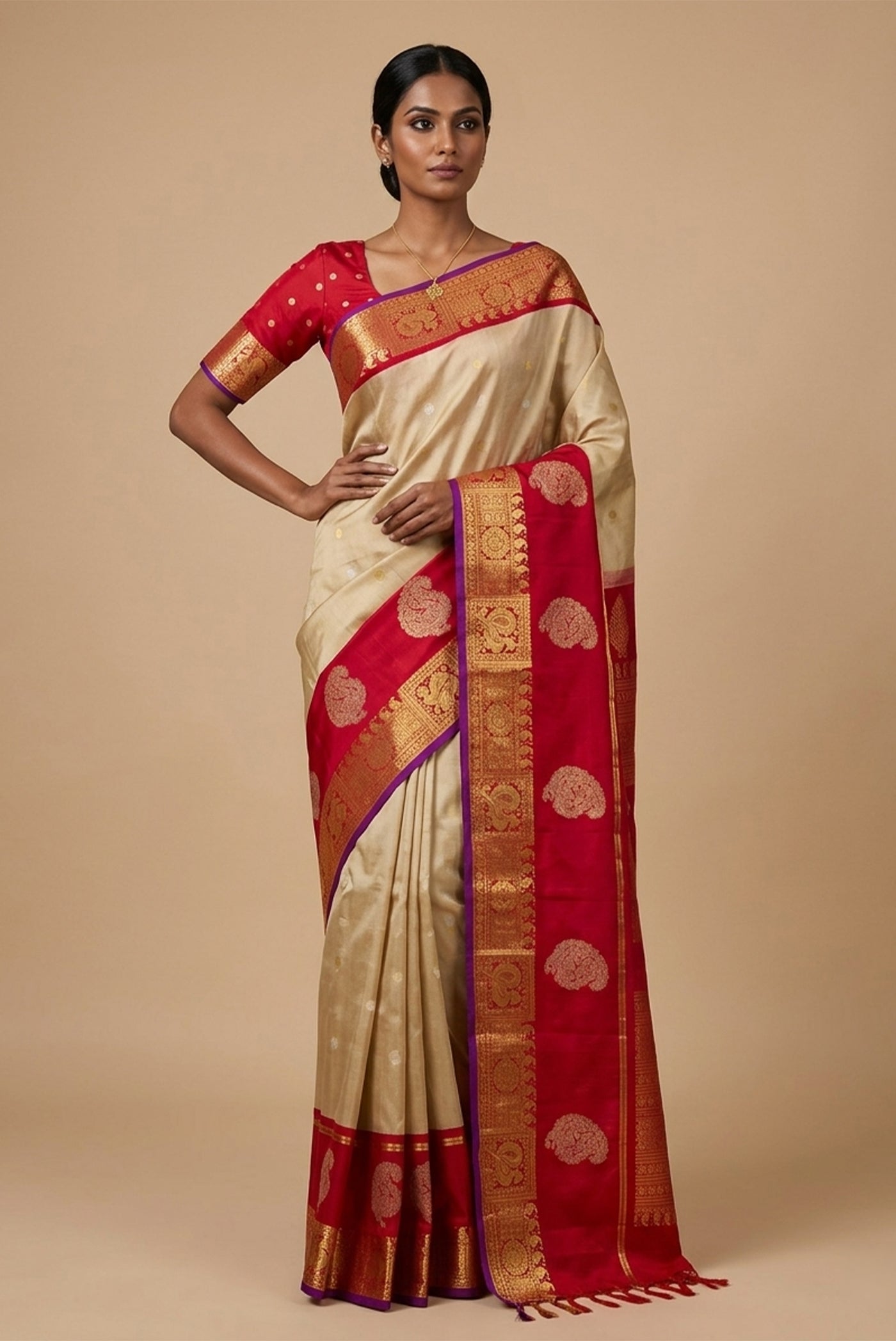 Model wearing a Beige Gadwal Silk Saree with Zari Butta on the body and Zari Border.